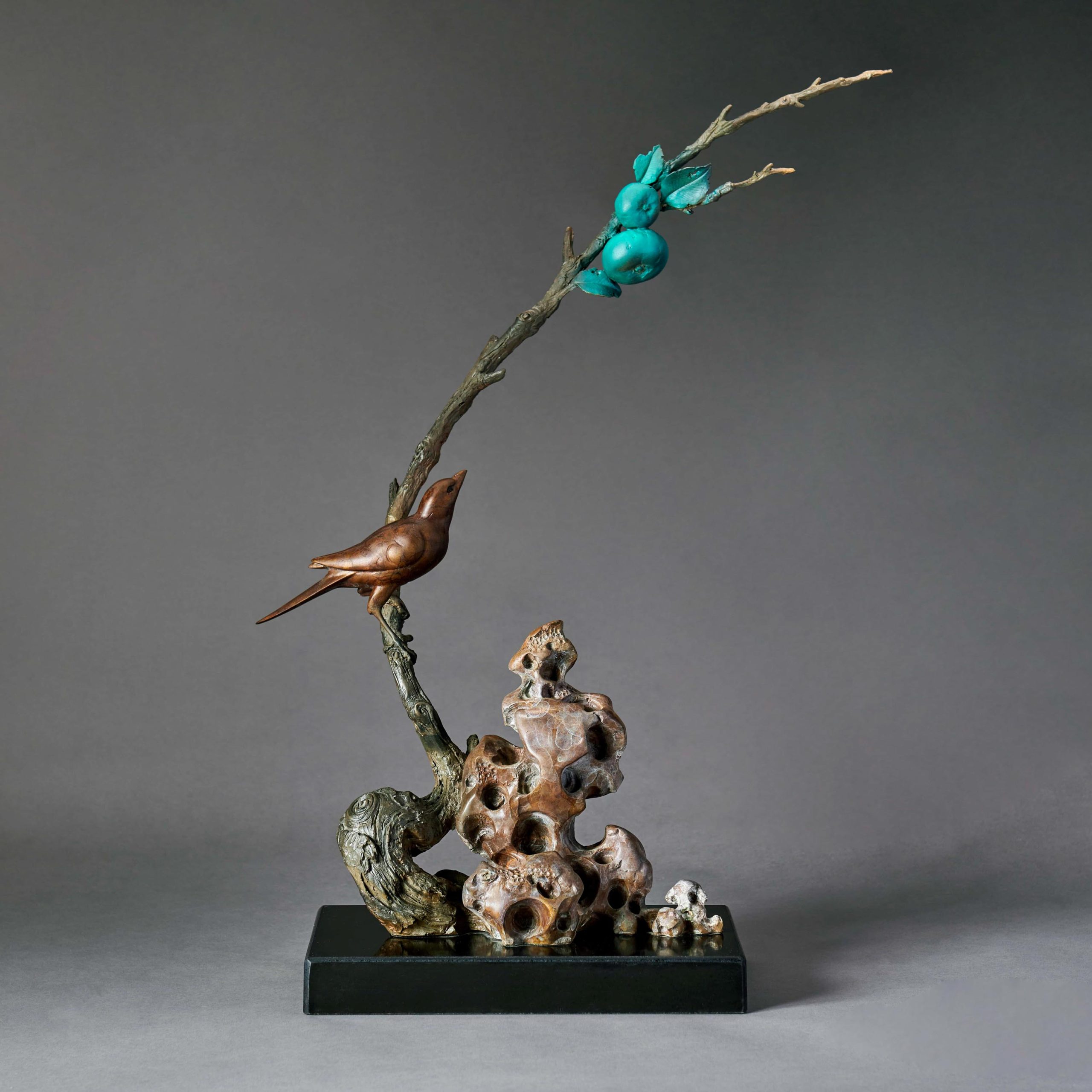 Birds on persimmon branch over scholars rocks — opposite three-quarter.