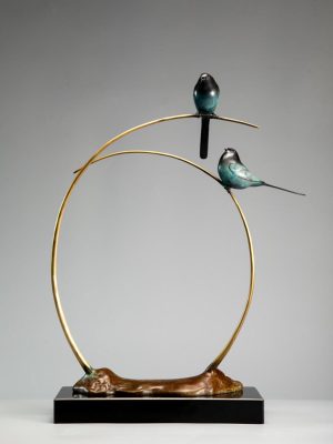 Two little birds stand on the branch