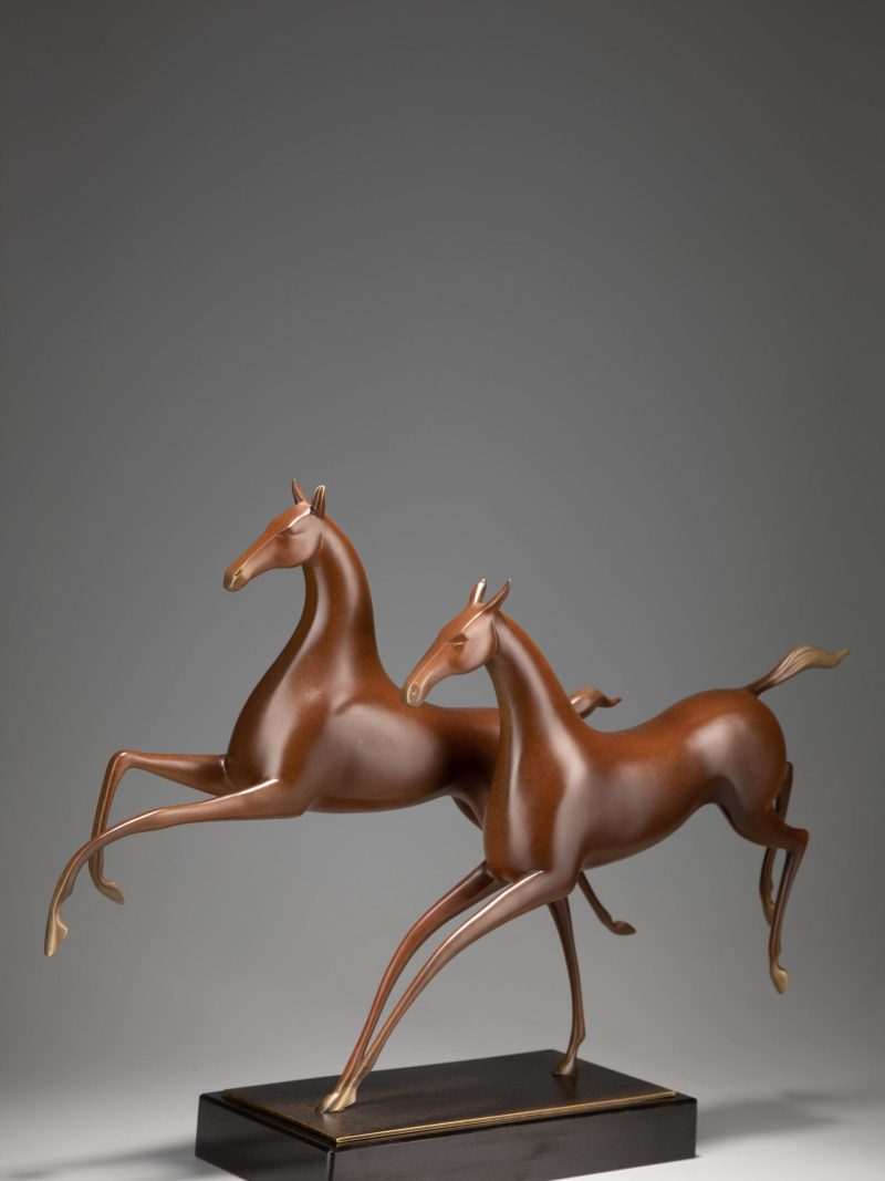 Two horses running side by side