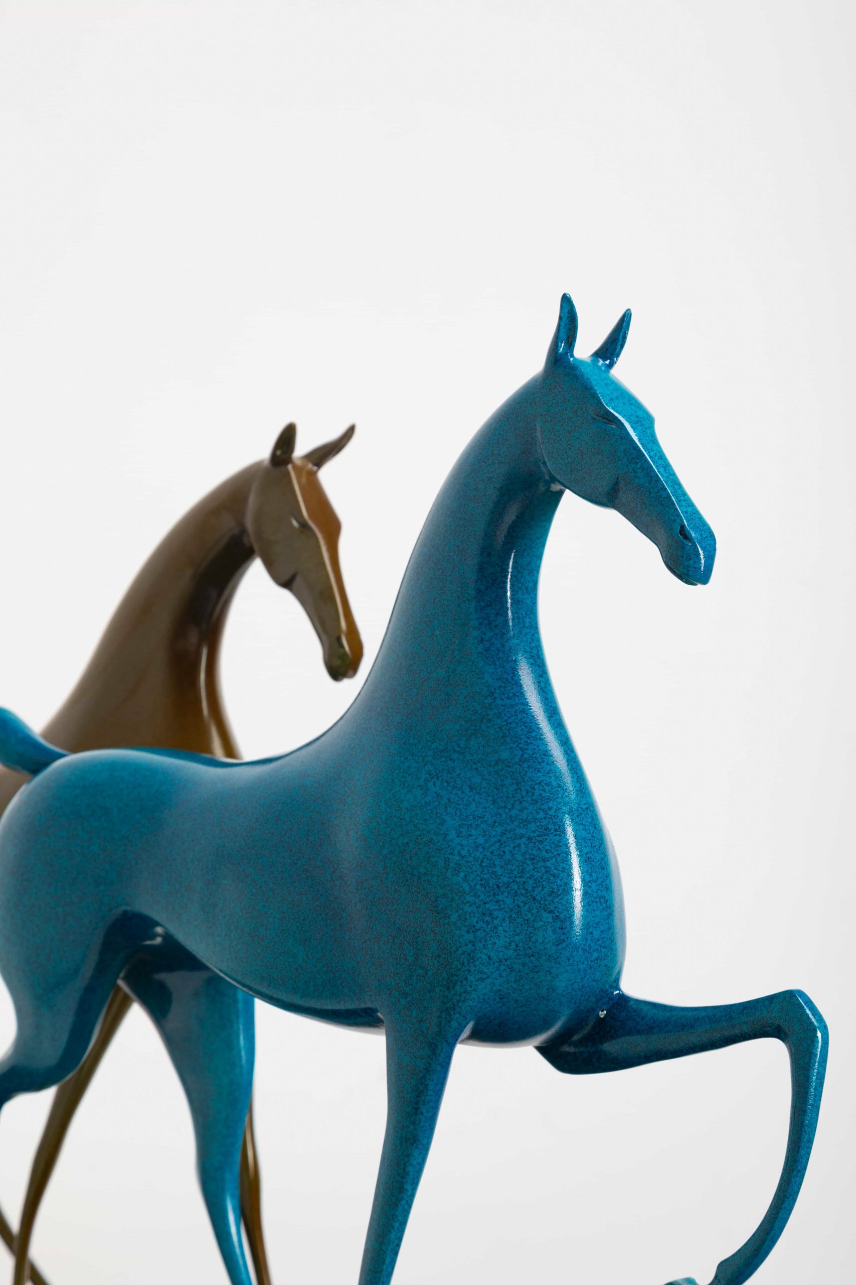 Running horse pair in turquoise and gold — close-up pair.