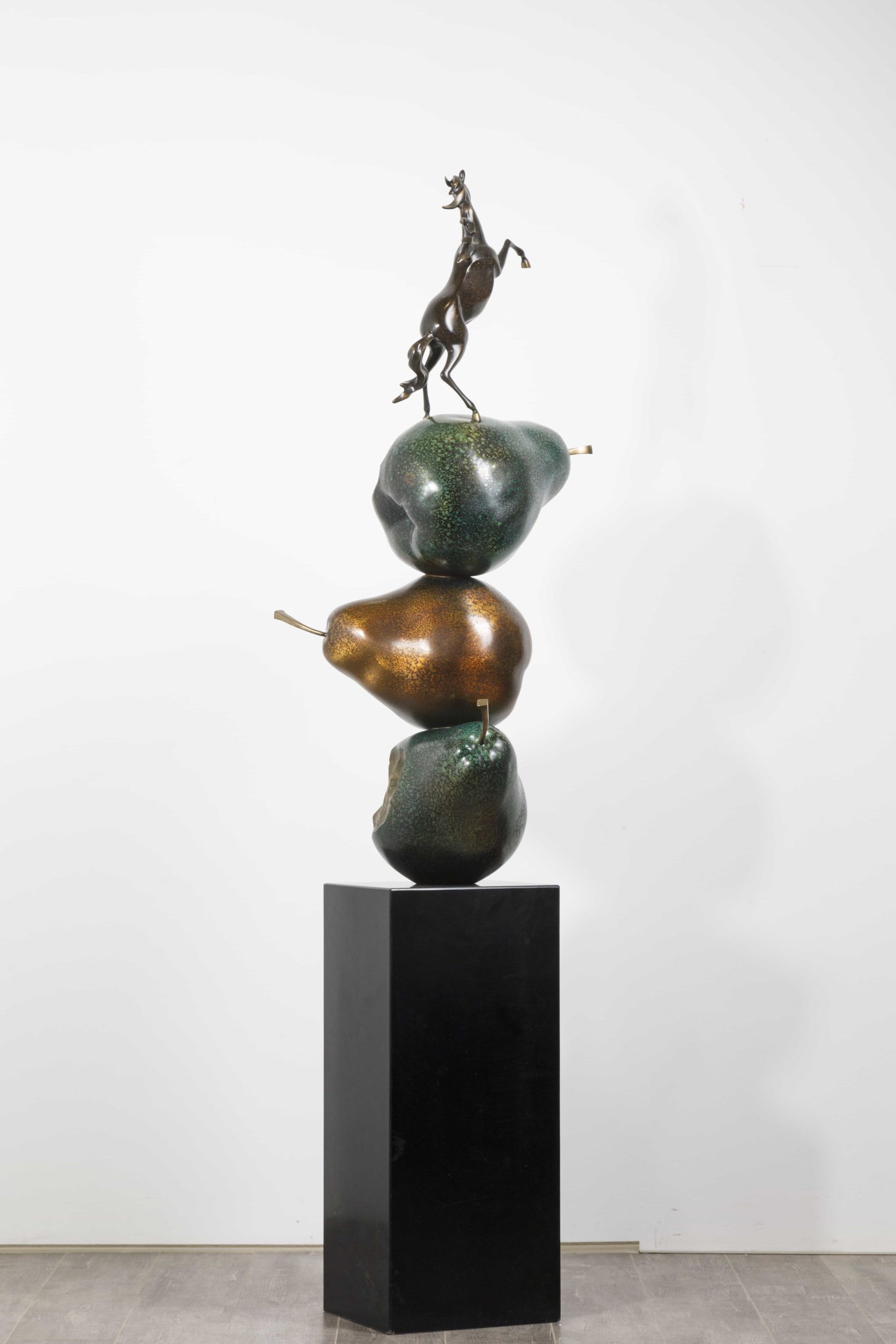 Dark bronze rearing horse atop stacked pears — full view alt.