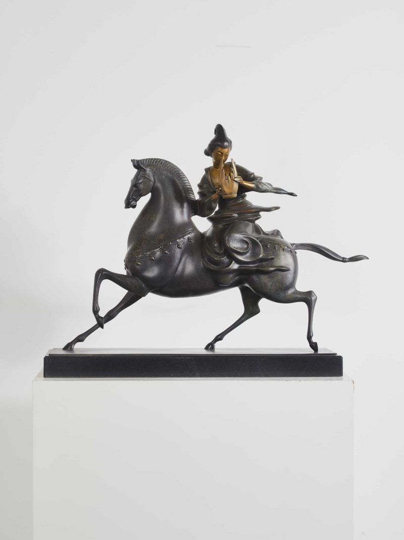 The woman playing the instrument while riding a horse