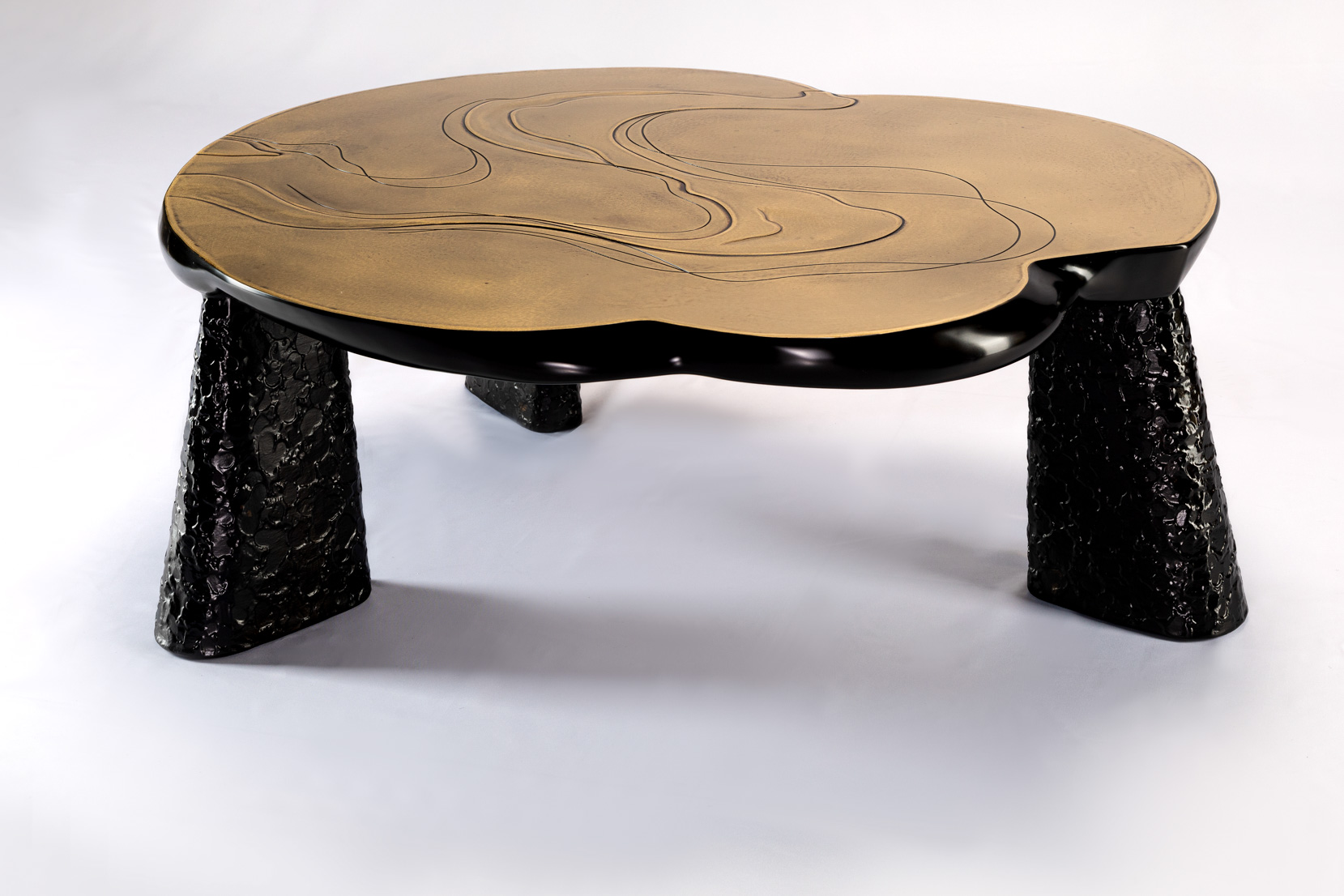 Sculptural bronze coffee table with cloud-form top and tapered legs