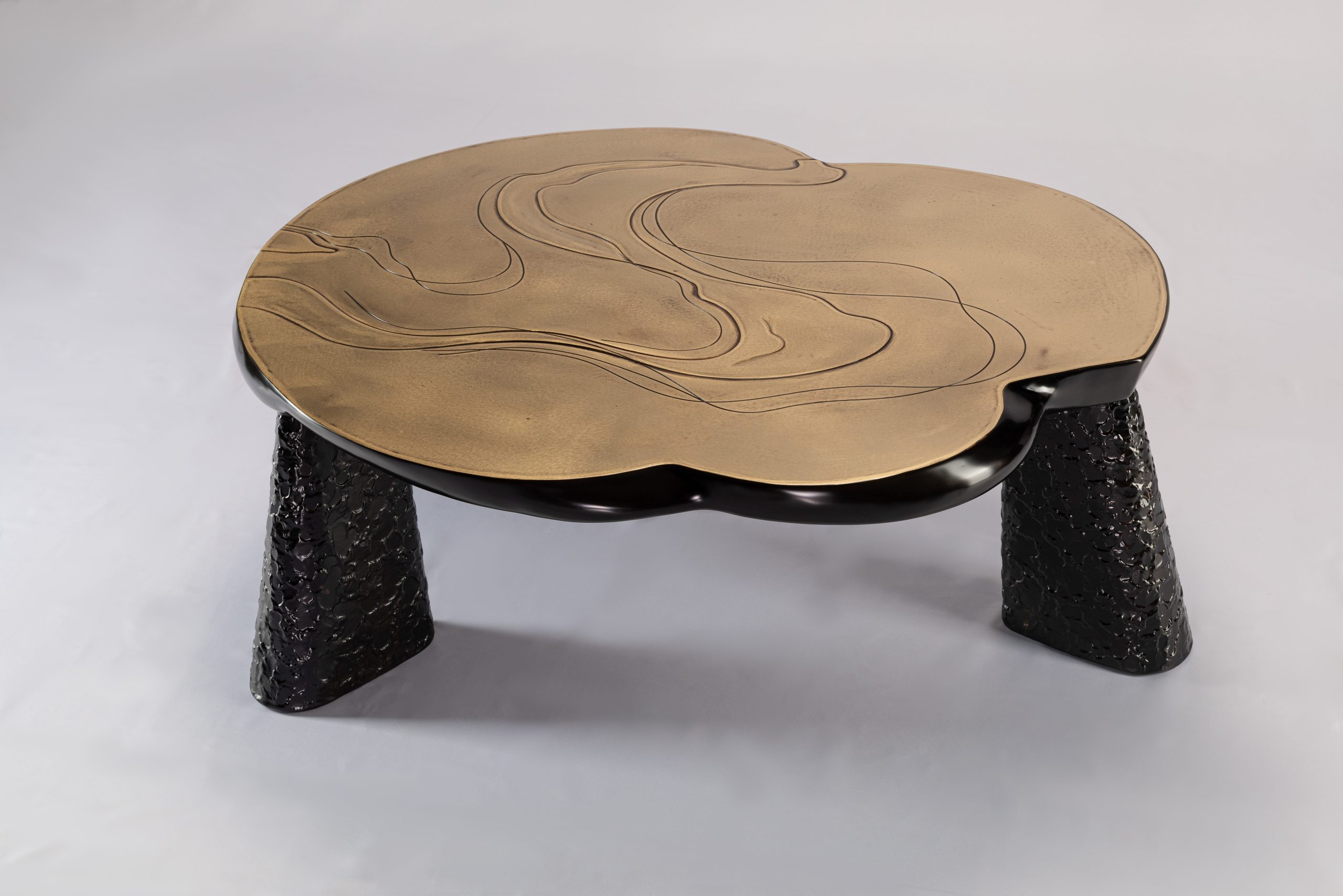 Bronze coffee table with black hammered conical legs, front view