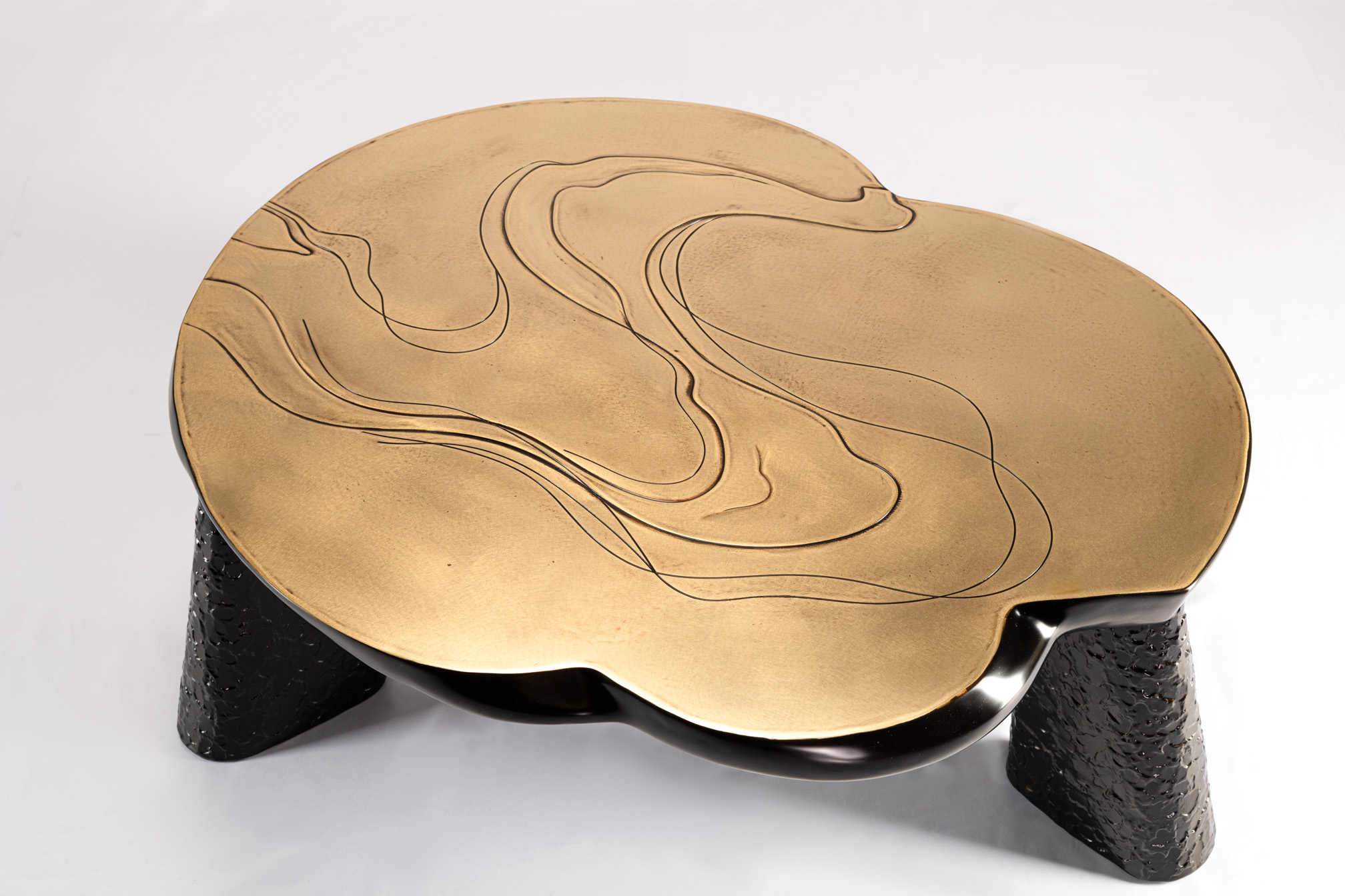 Top view showing engraved water ripple lines on the bronze coffee table surface