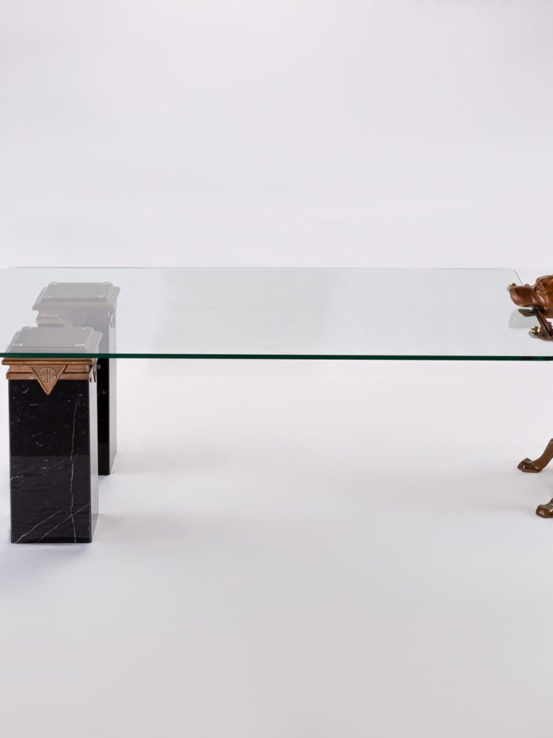 Bronze dog coffee table holding the glass top in its mouth, side view
