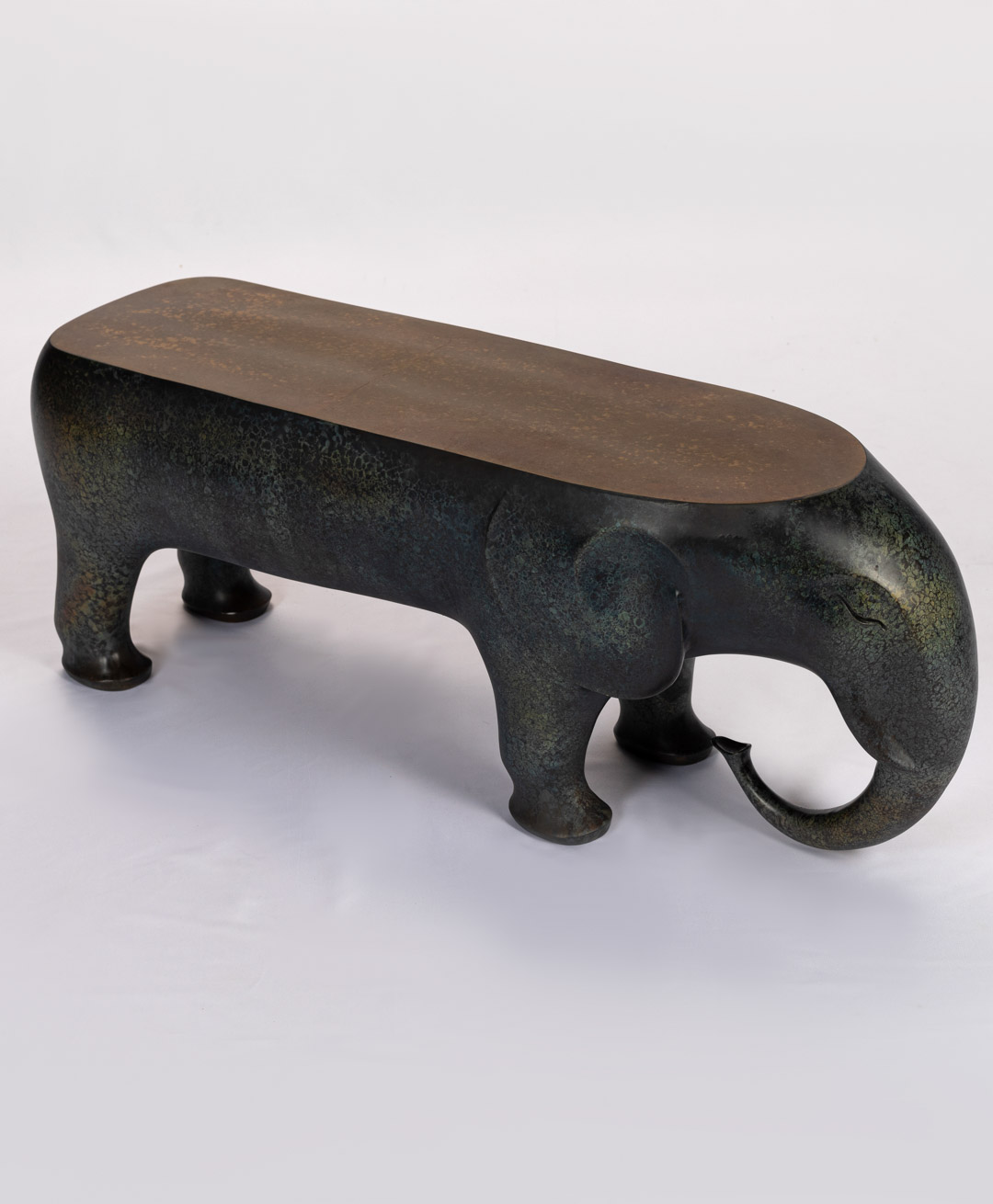 Angled view of the bronze elephant bench showing trunk and tusks