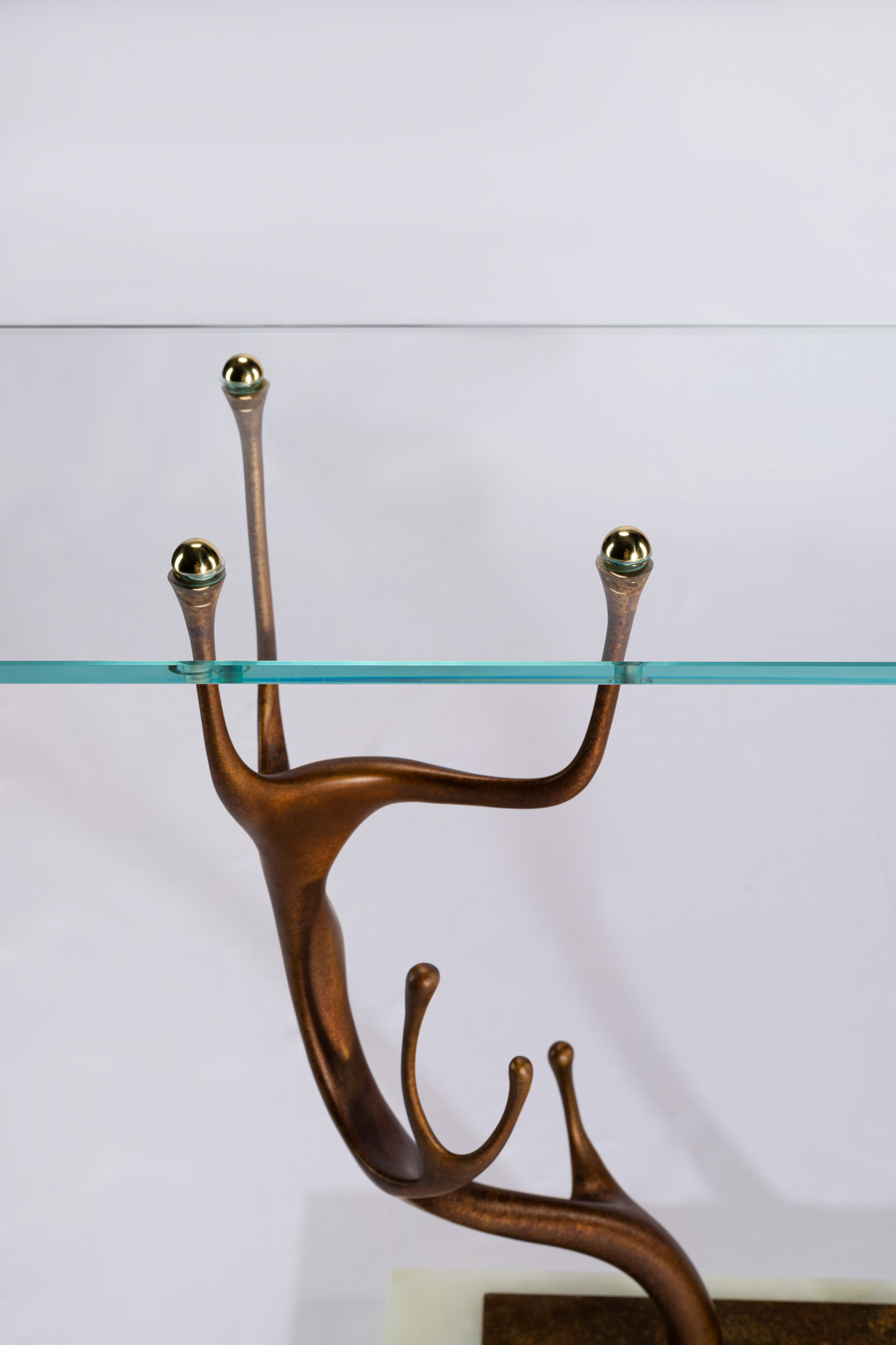 Detail of the deer antler bronze leg and brass ball finials supporting the glass top