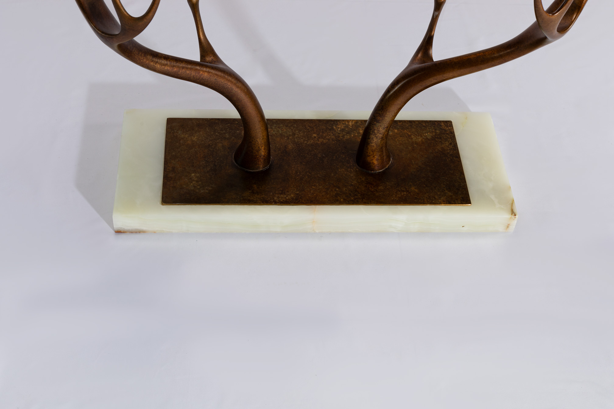 Detail of the stone base and bronze mounting plate of the console table