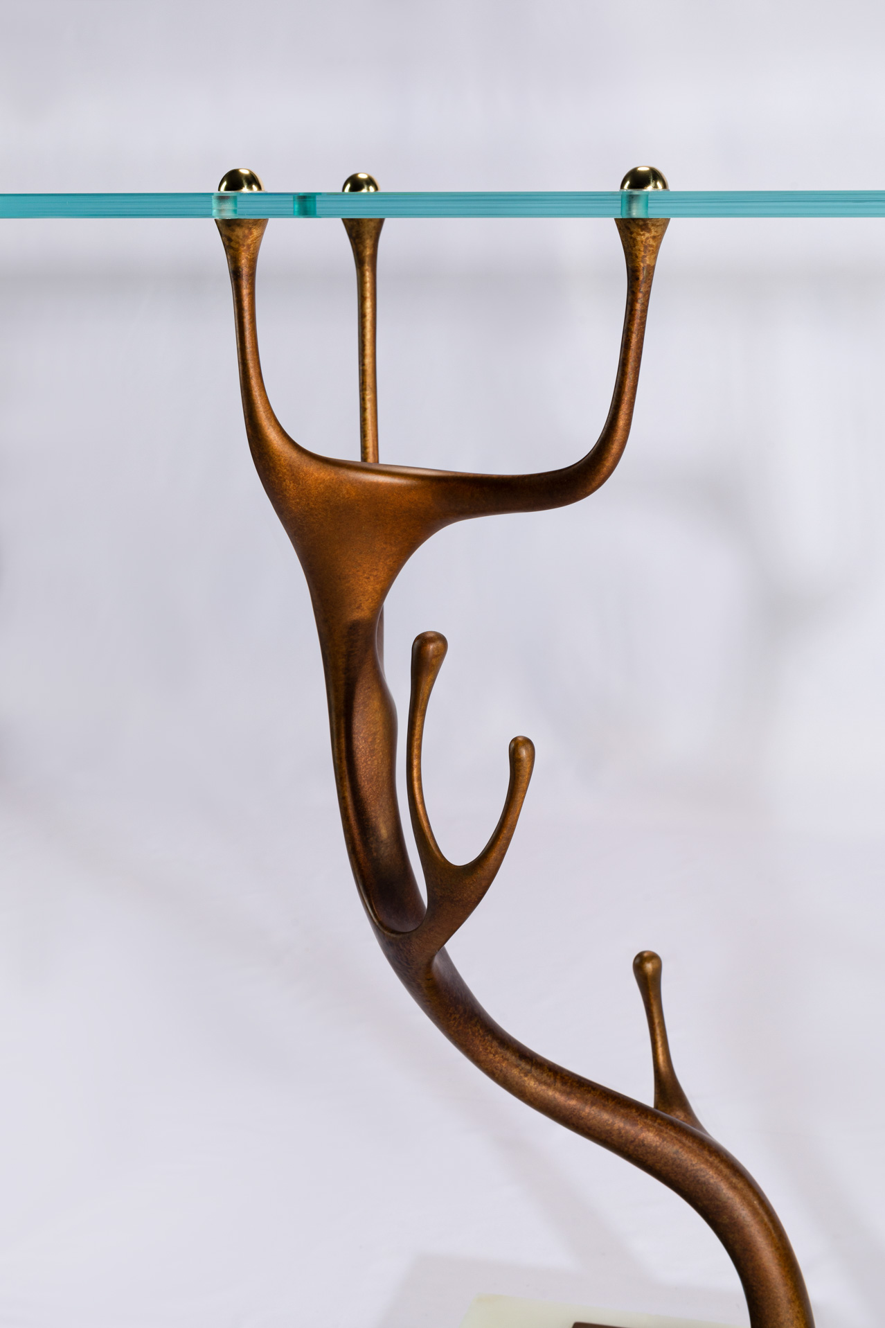 Side view of a cast bronze antler leg of the console table