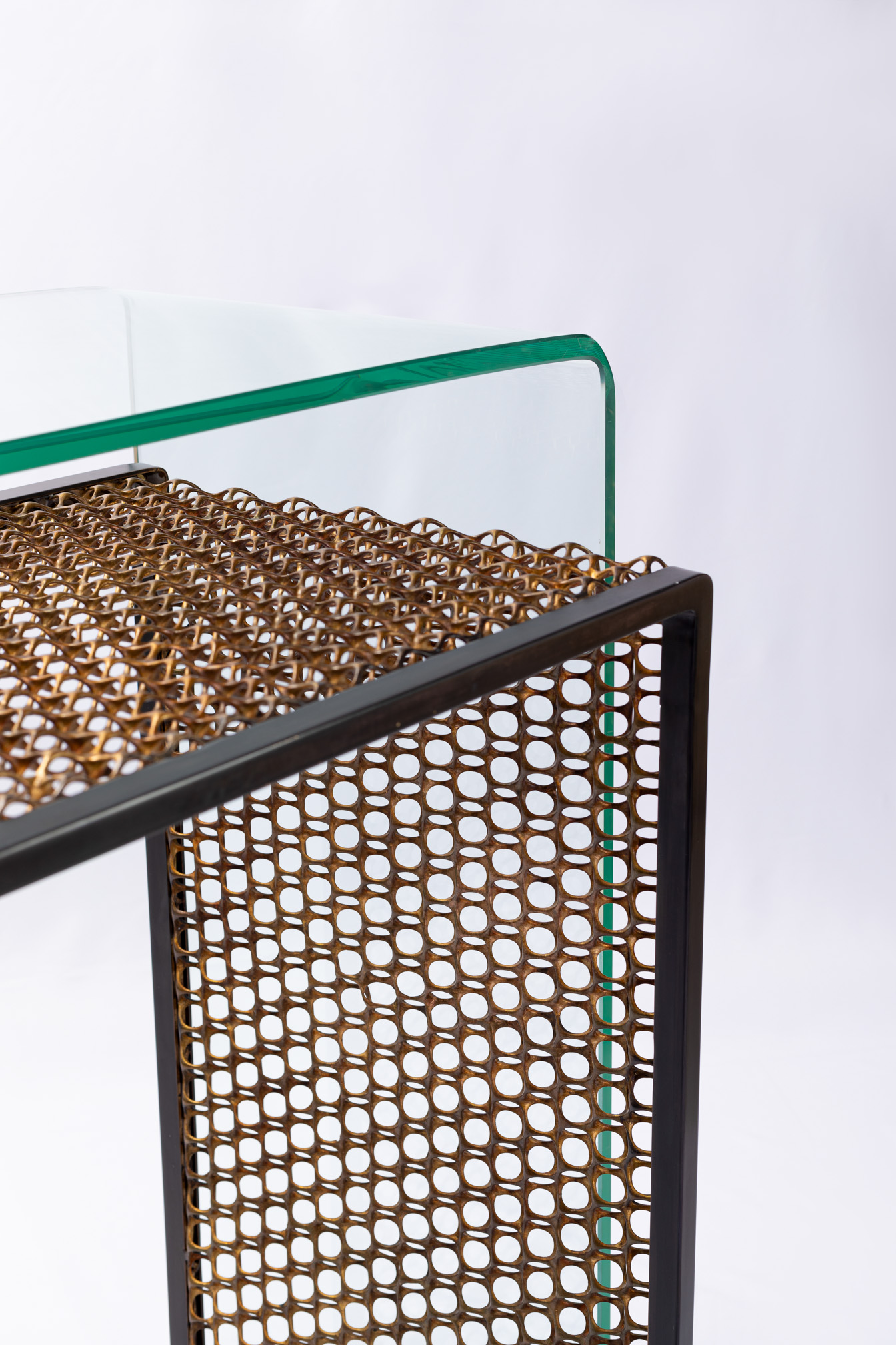 Close-up of the woven bronze mesh texture in the console frame
