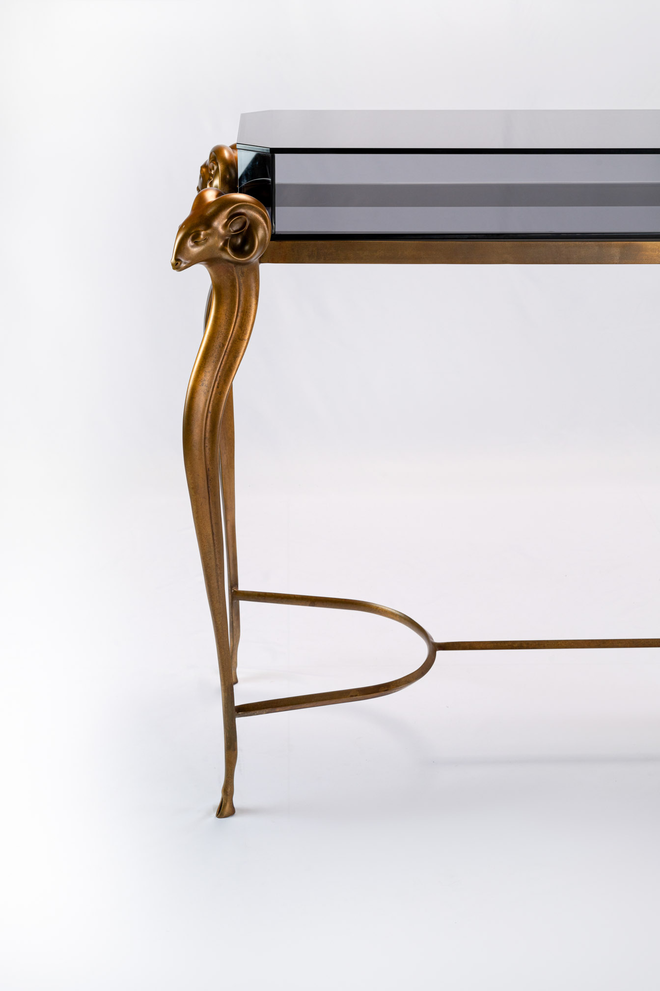 Bronze console table leg with curved stretcher, close-up