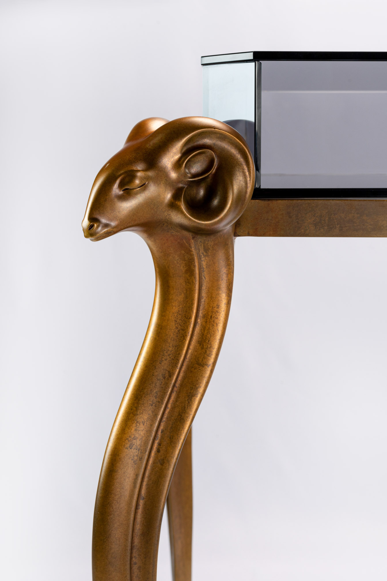 Detail of the bronze antelope head under the smoked glass top
