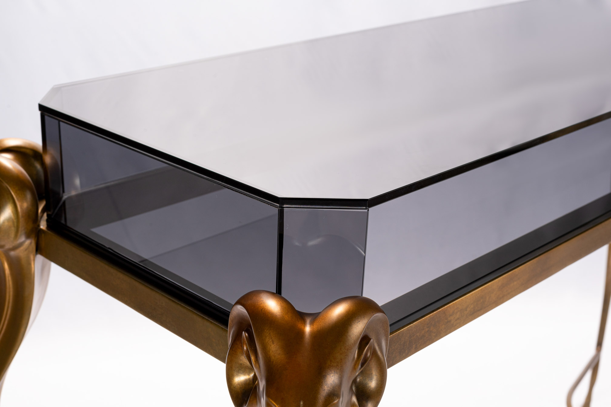 Close-up of the antelope head and smoked glass corner of the console table