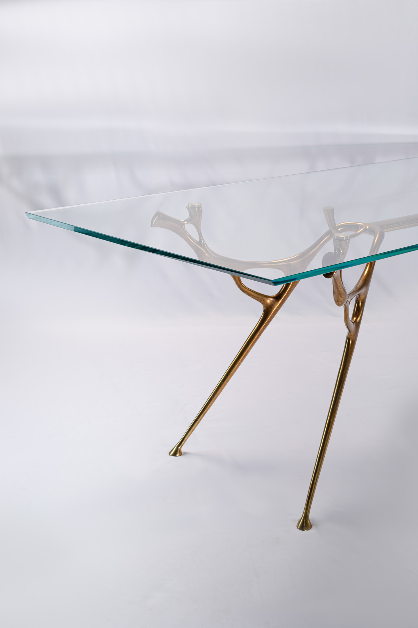 Low three-quarter view of the bronze dining table base