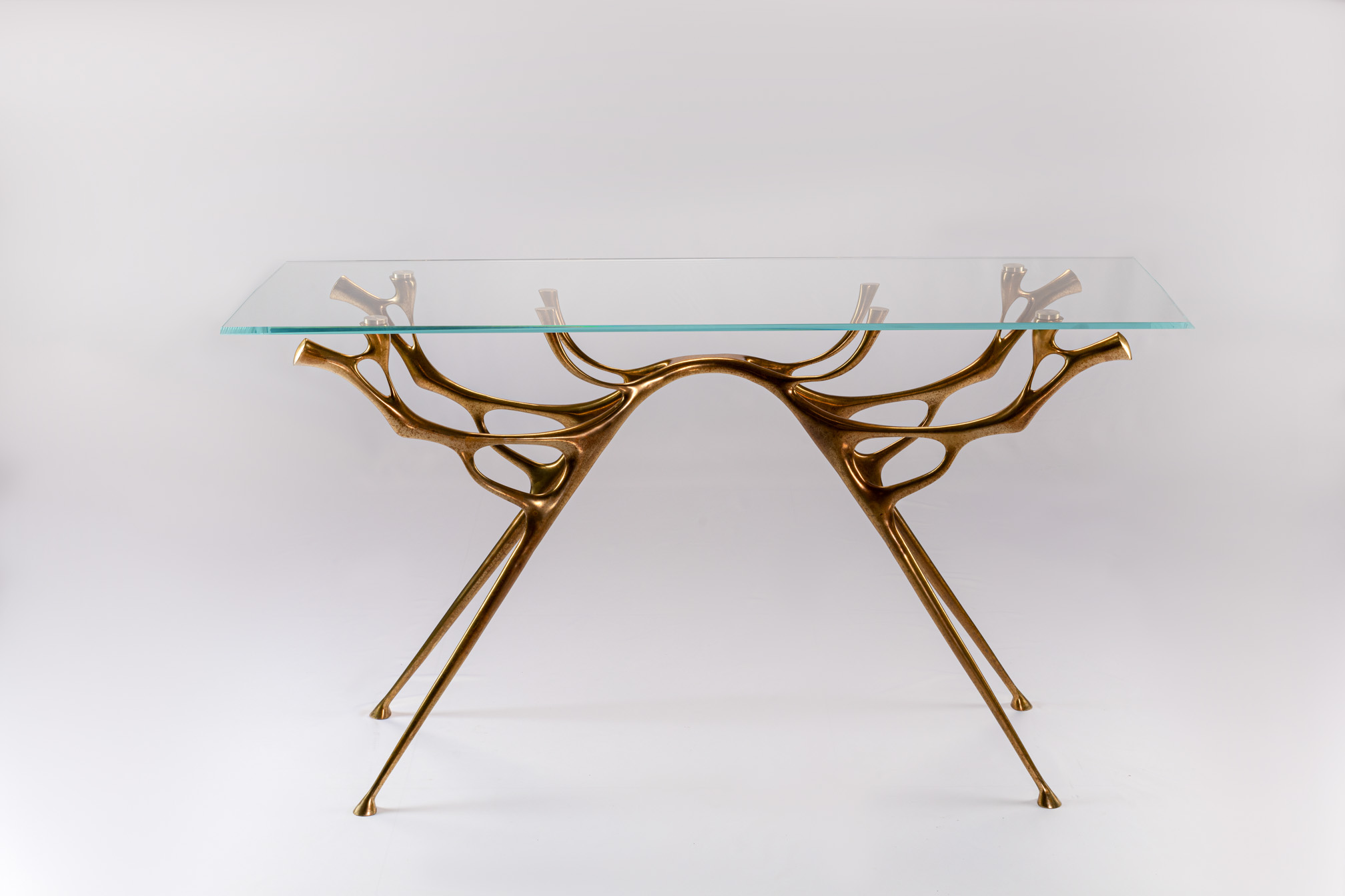 Front view of the bronze console table with glass top
