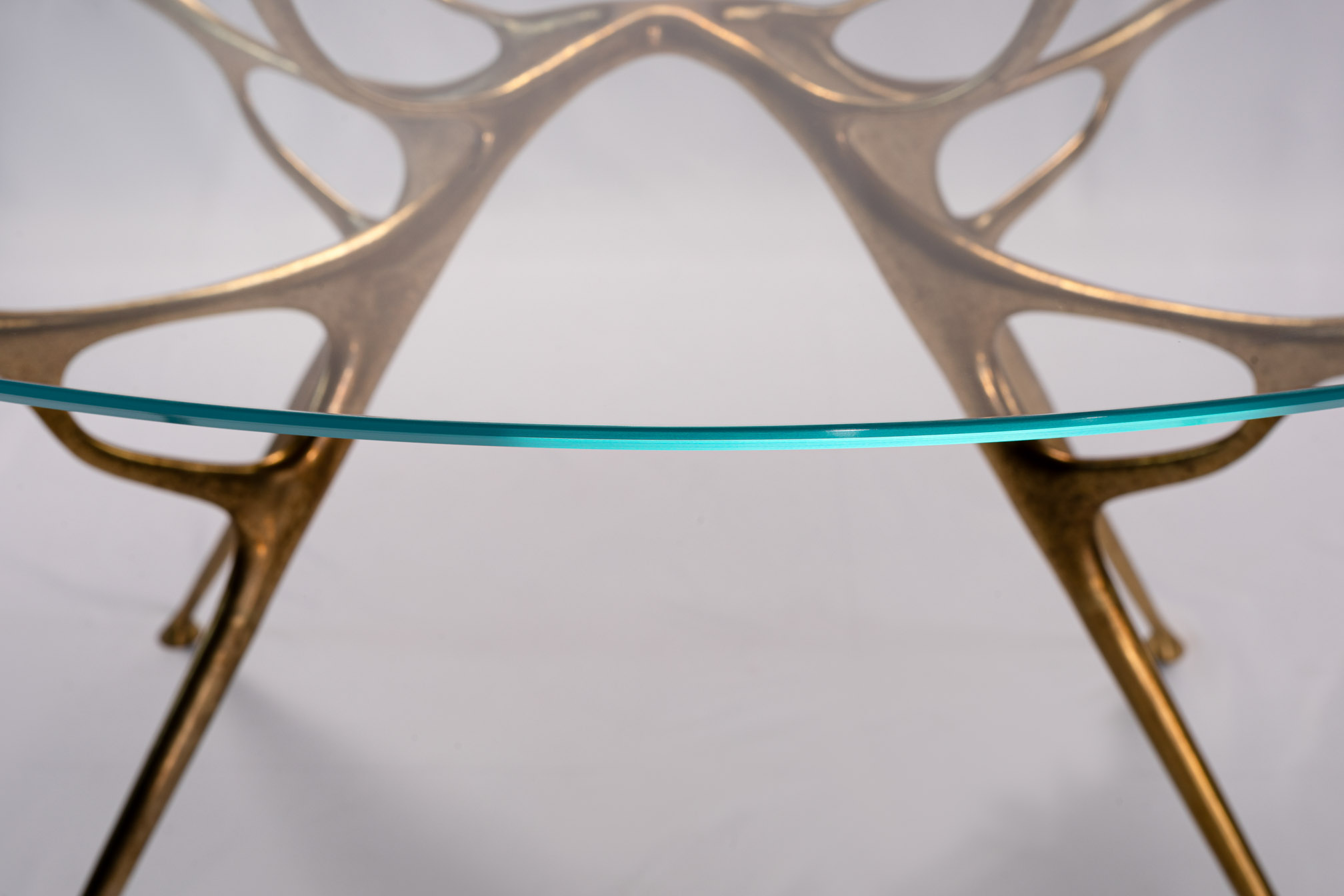 Close-up of the bronze branch arch under the round glass top