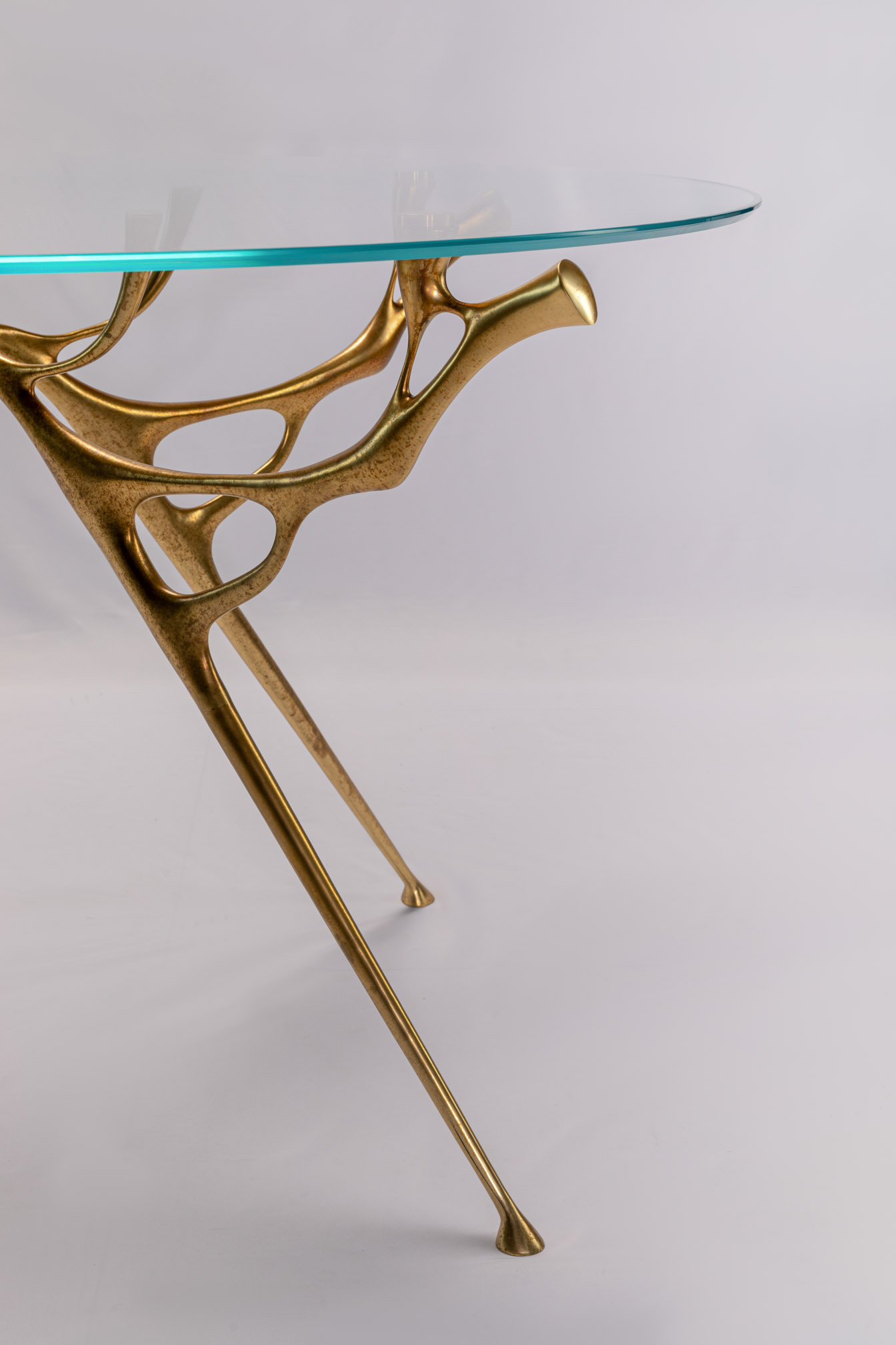 Close-up of the bronze branch legs of the round table
