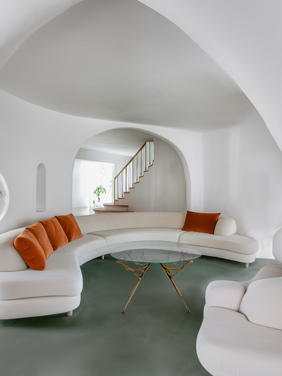 Lifestyle rendering of the round bronze dining table in a curved living room