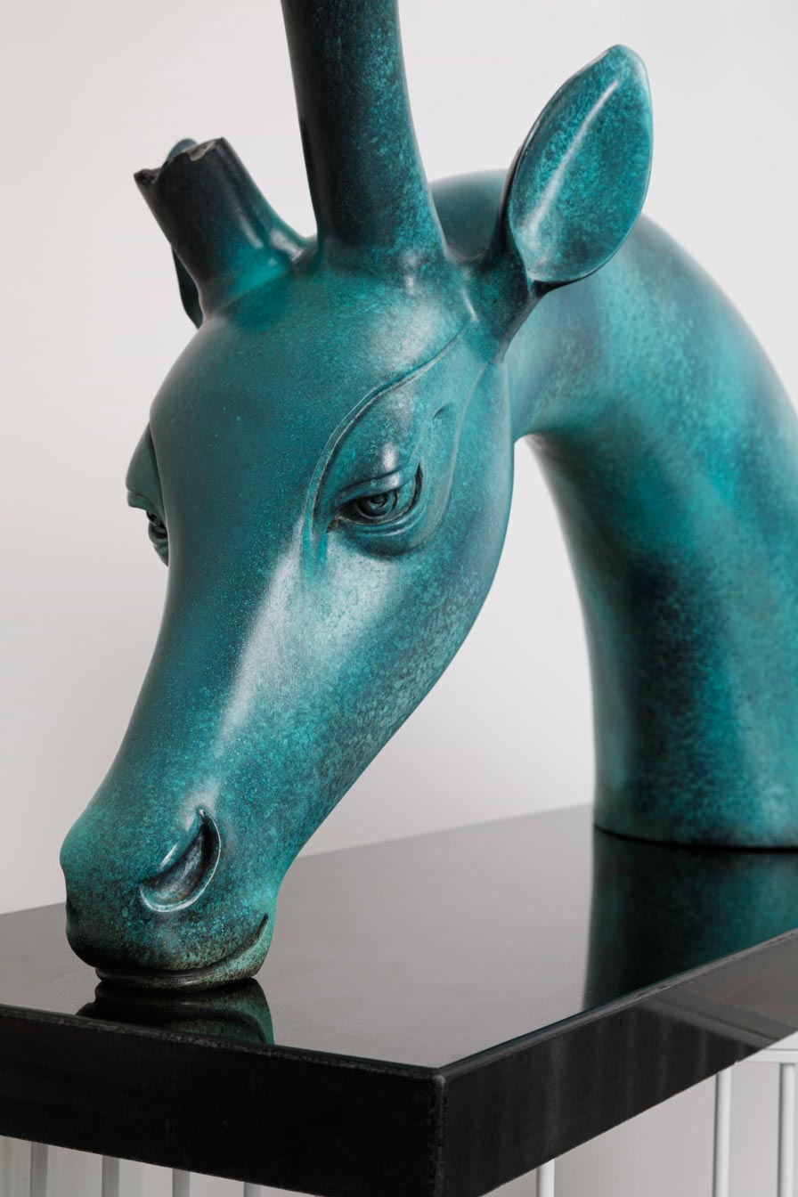 Large teal patina deer with tree-canopy antlers — head close-up.