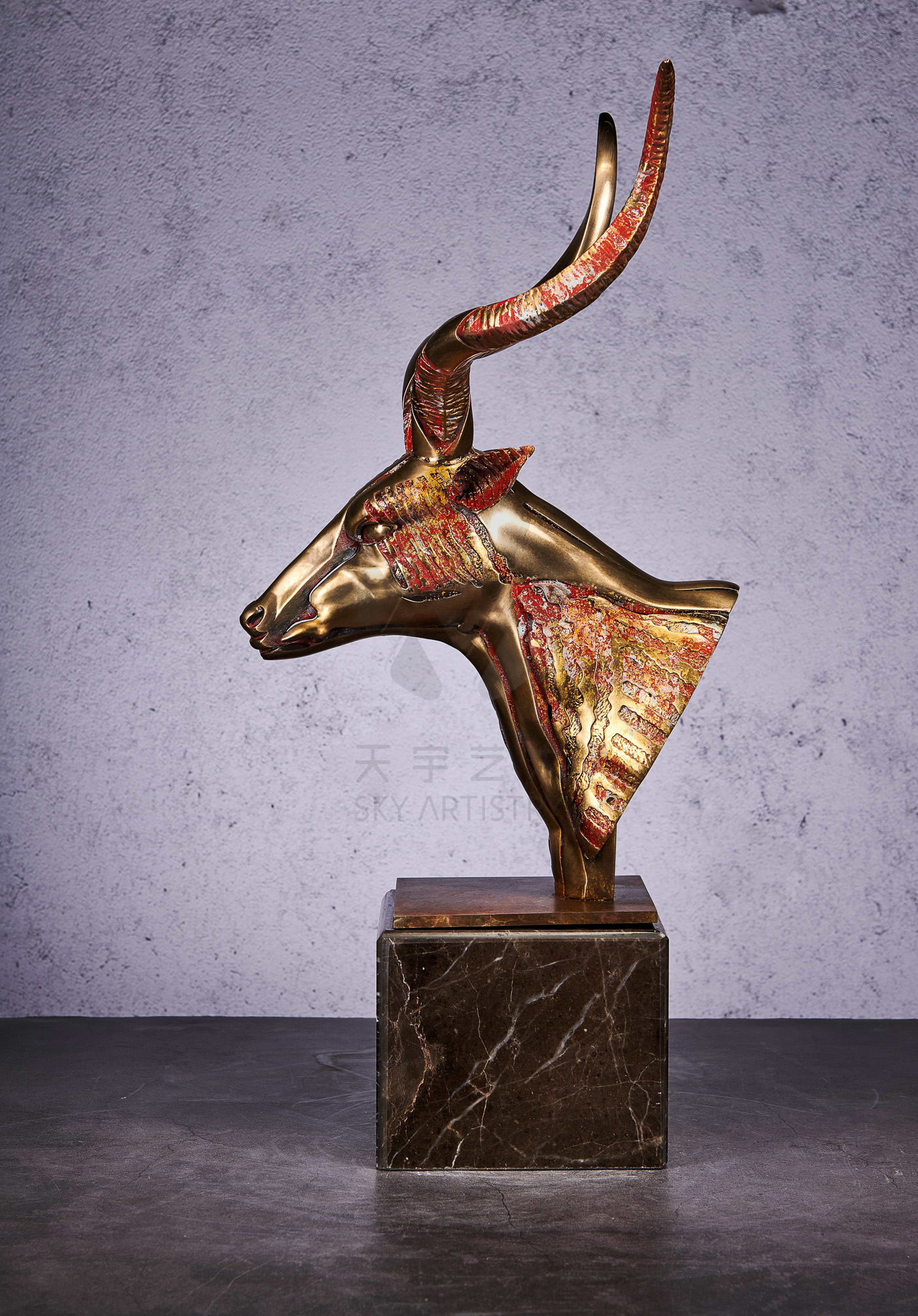 Deconstructed antelope bust in gold and coral — front view.