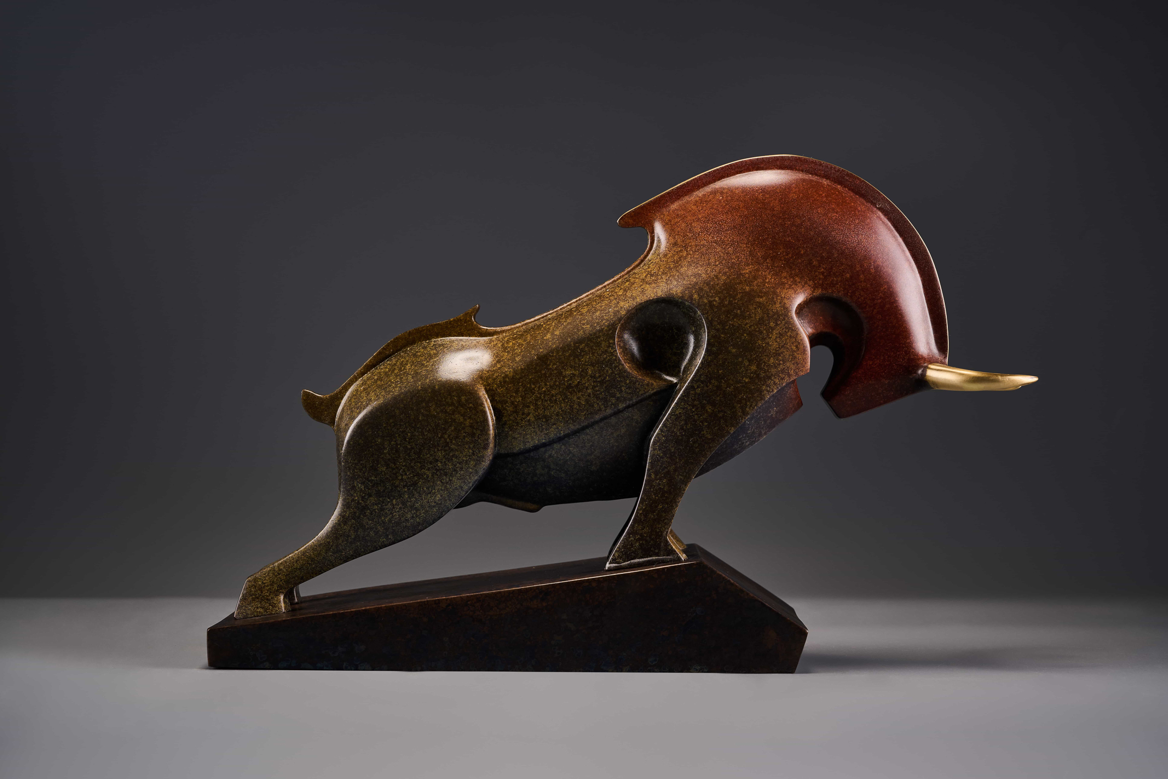 Abstract charging bull with red crest — opposite three-quarter.