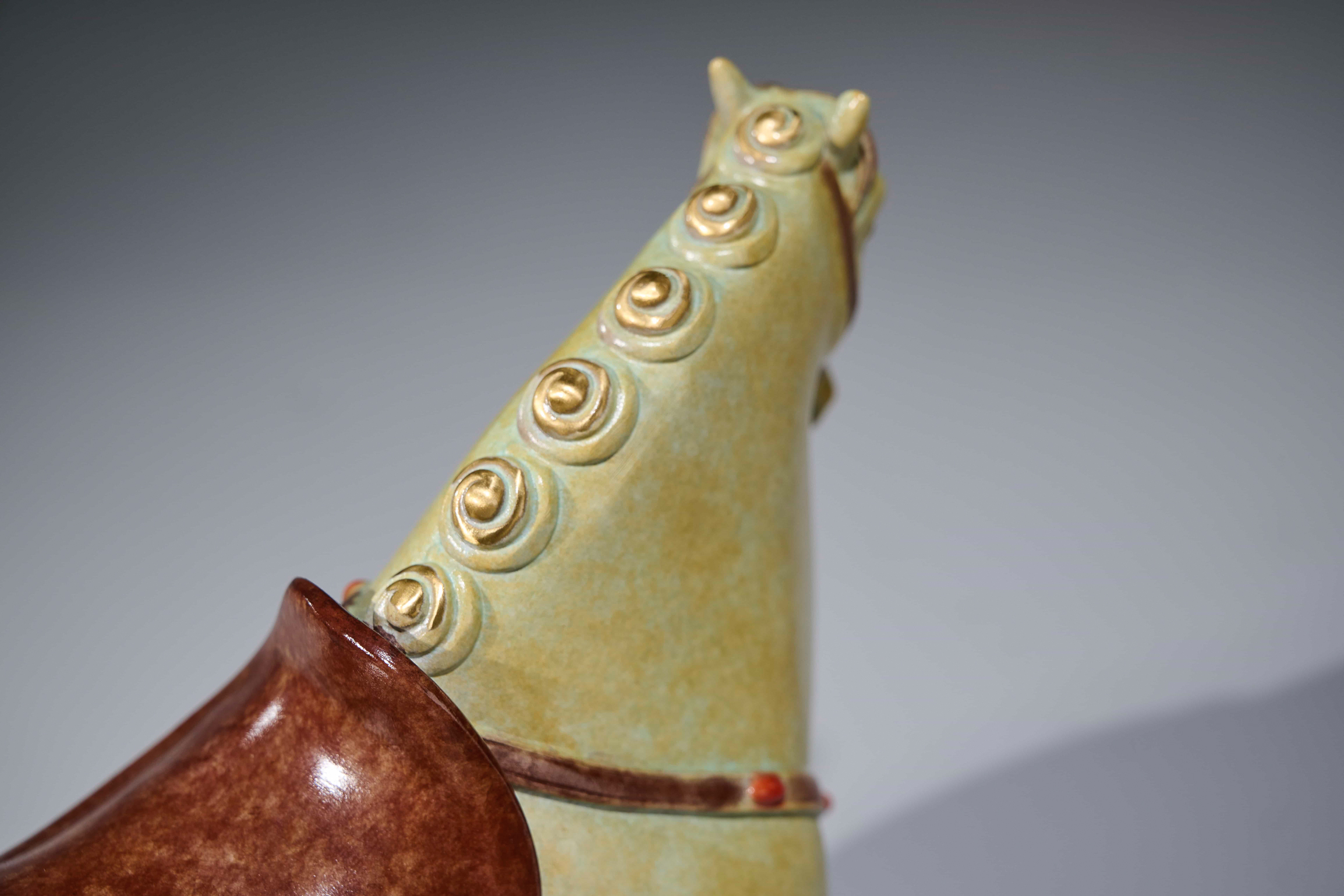 Celadon-glazed tang-style horse with red saddle — mane detail close-up.