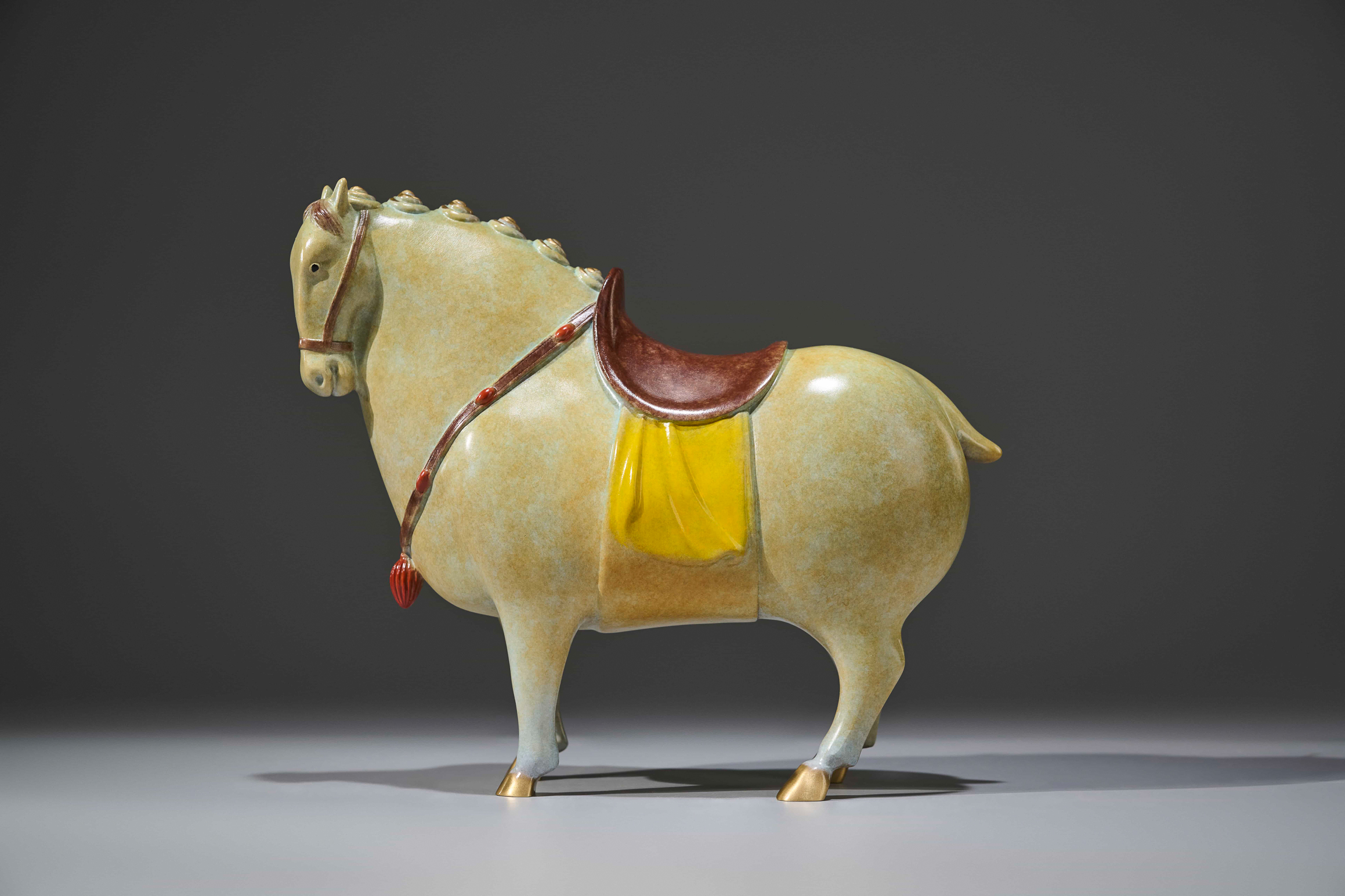 Celadon-glazed tang-style horse with red saddle — side view.
