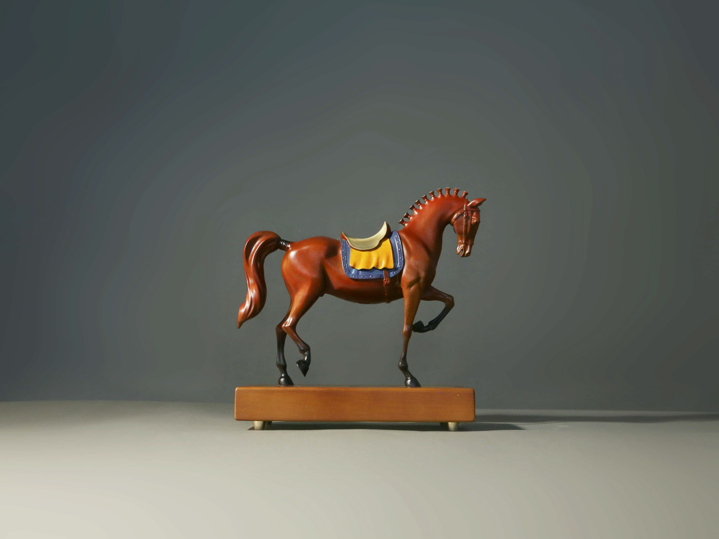 Reddish-brown tang-style horse with painted saddle — front three-quarter.