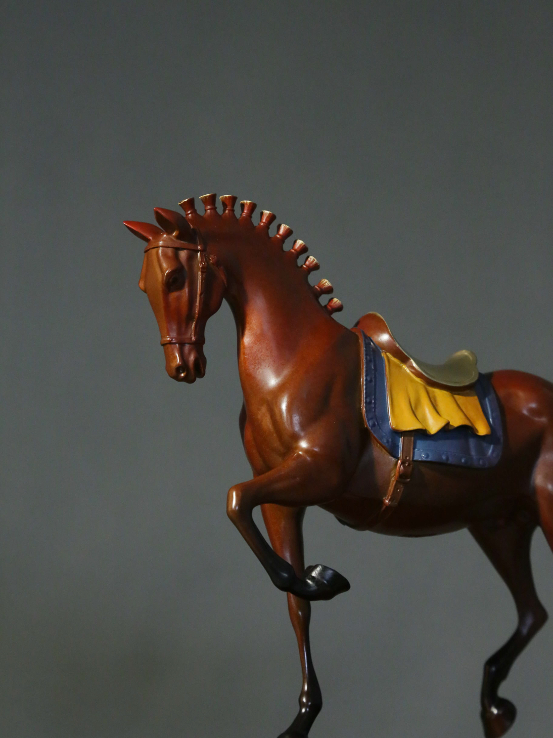 Reddish-brown tang-style horse with painted saddle — head and saddle close-up.