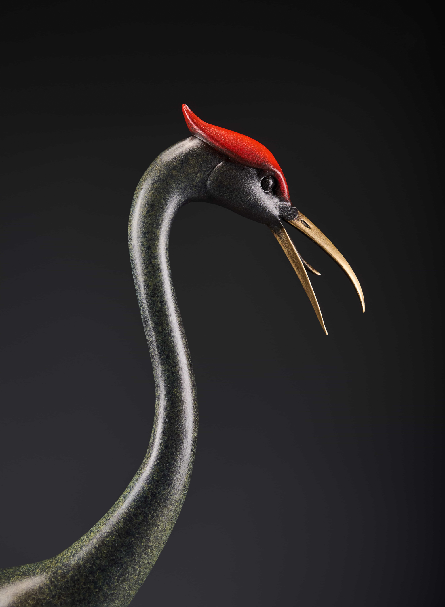 Silver crane with spread wings and red crown — head and neck close-up.