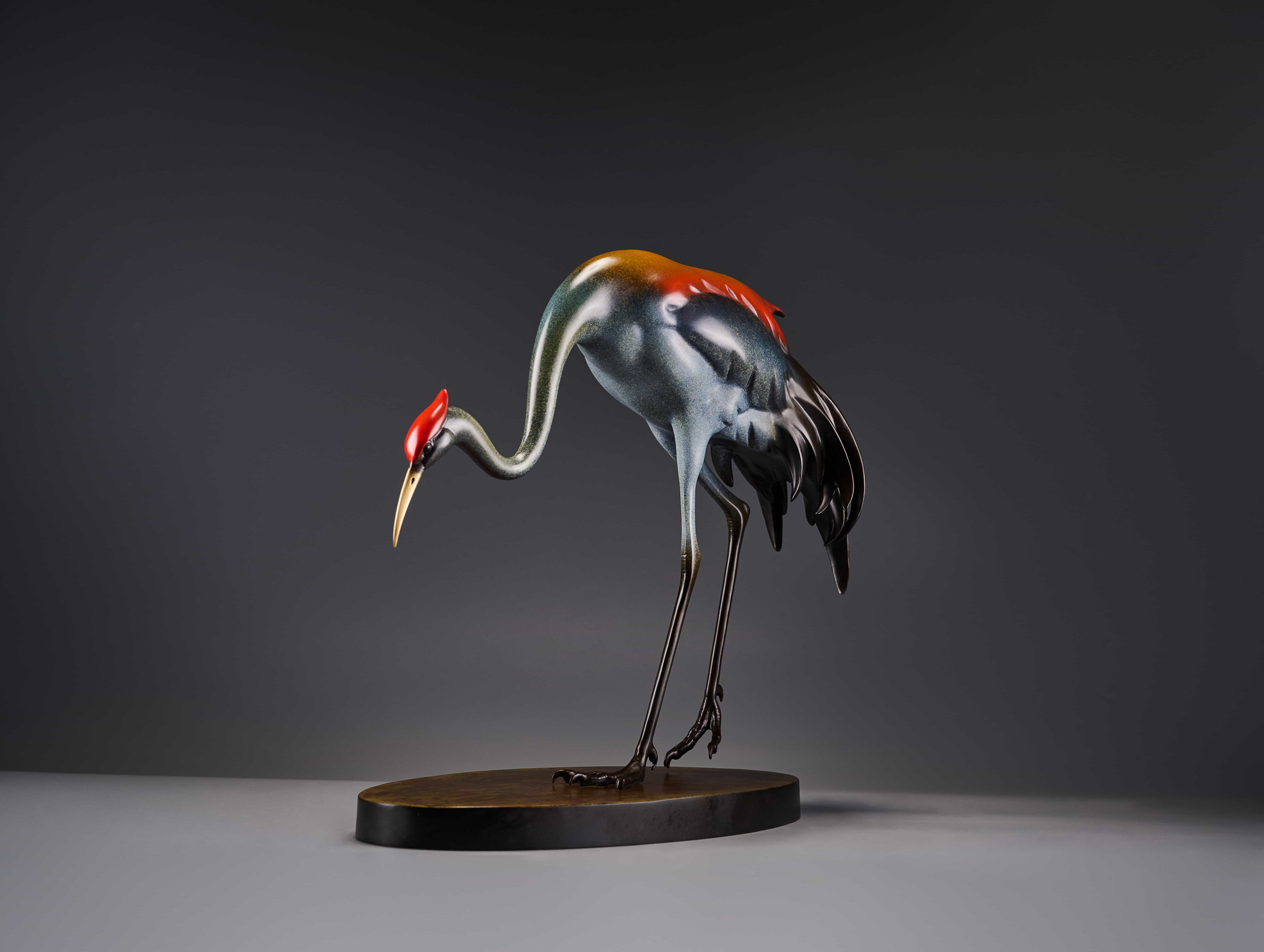 Red-crowned crane preening — alt angle view.