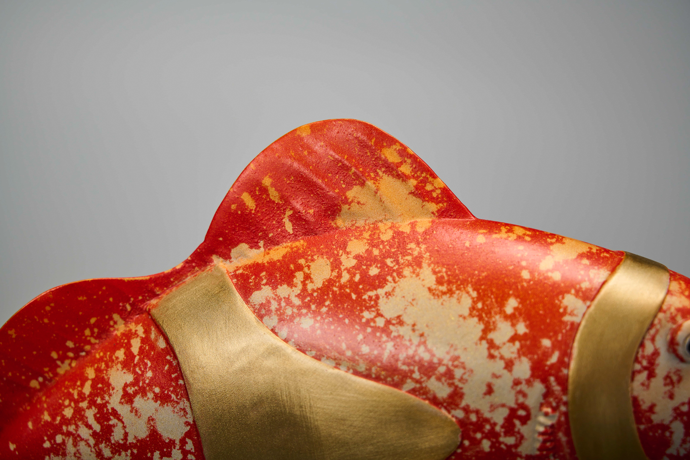 Red clownfish pair forming heart — back close-up.