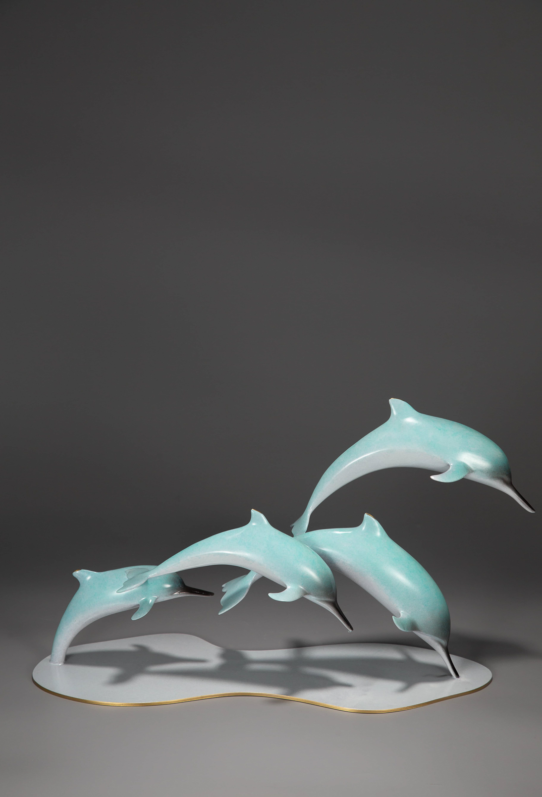 Dolphin group leaping over wave base — group alt angle.