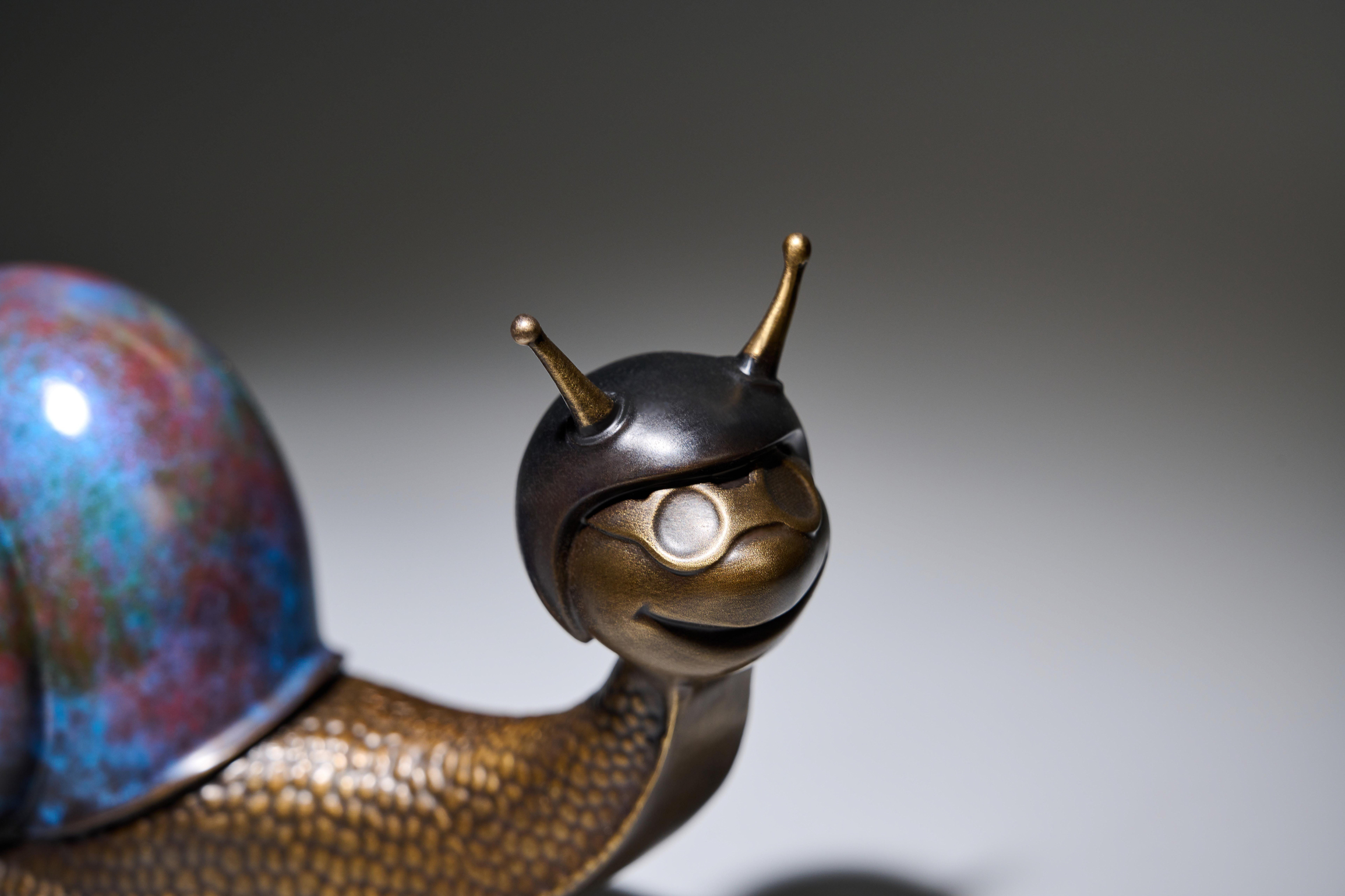 Copper snail with blue shell — head close-up.