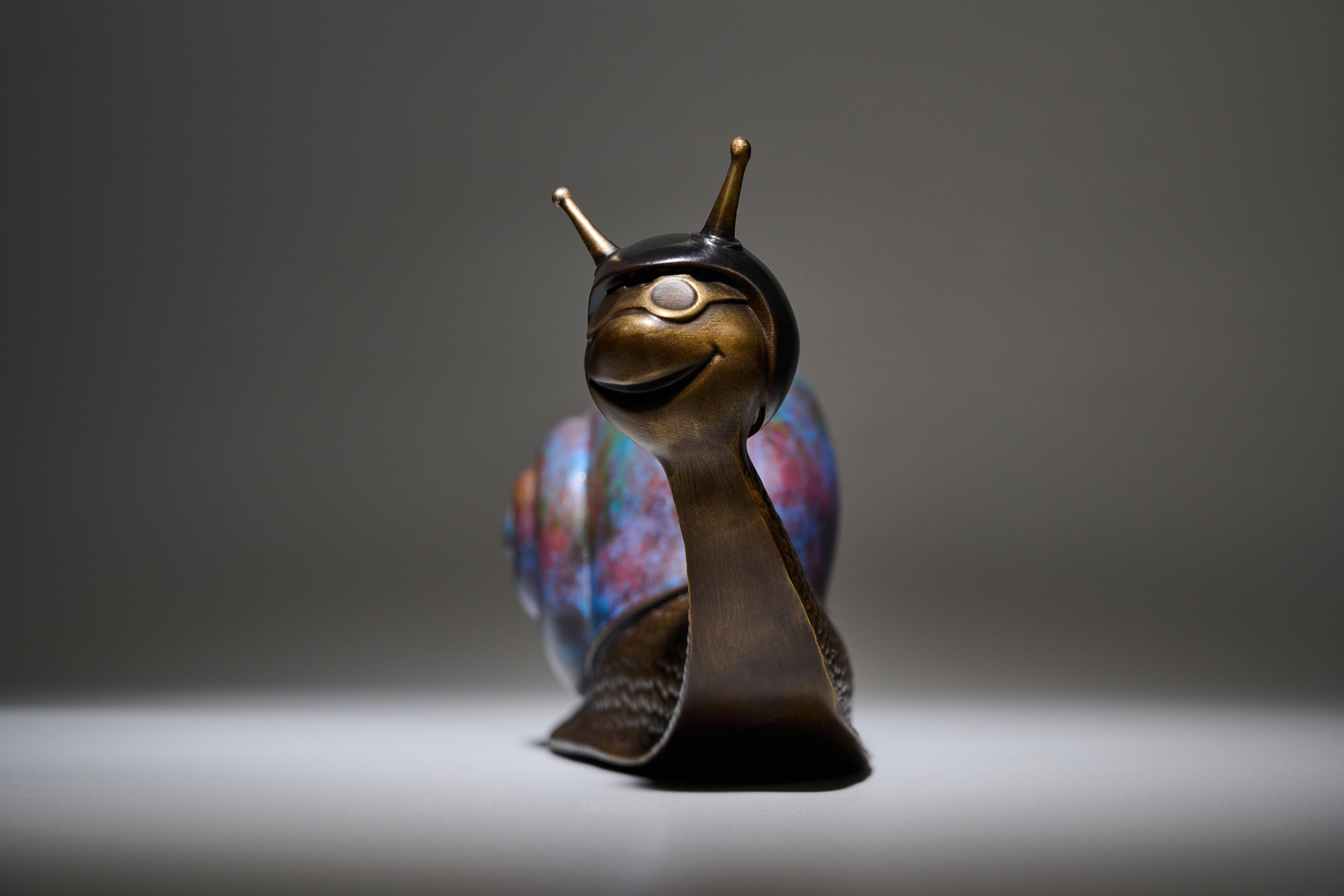 Copper snail with blue shell — front view.