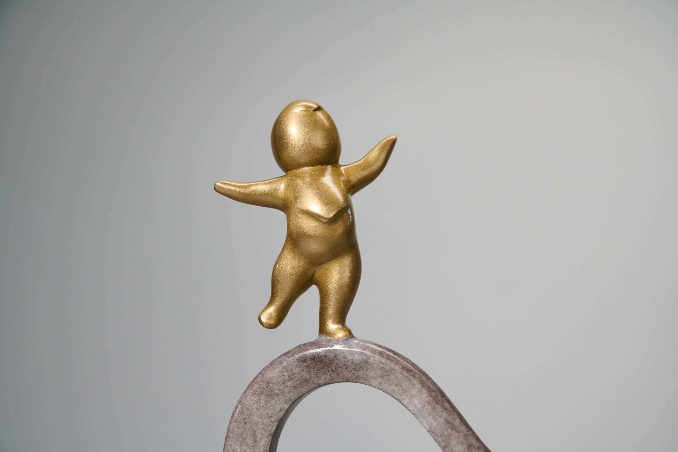 Two elephants with golden figures on trunks — golden figure close-up.