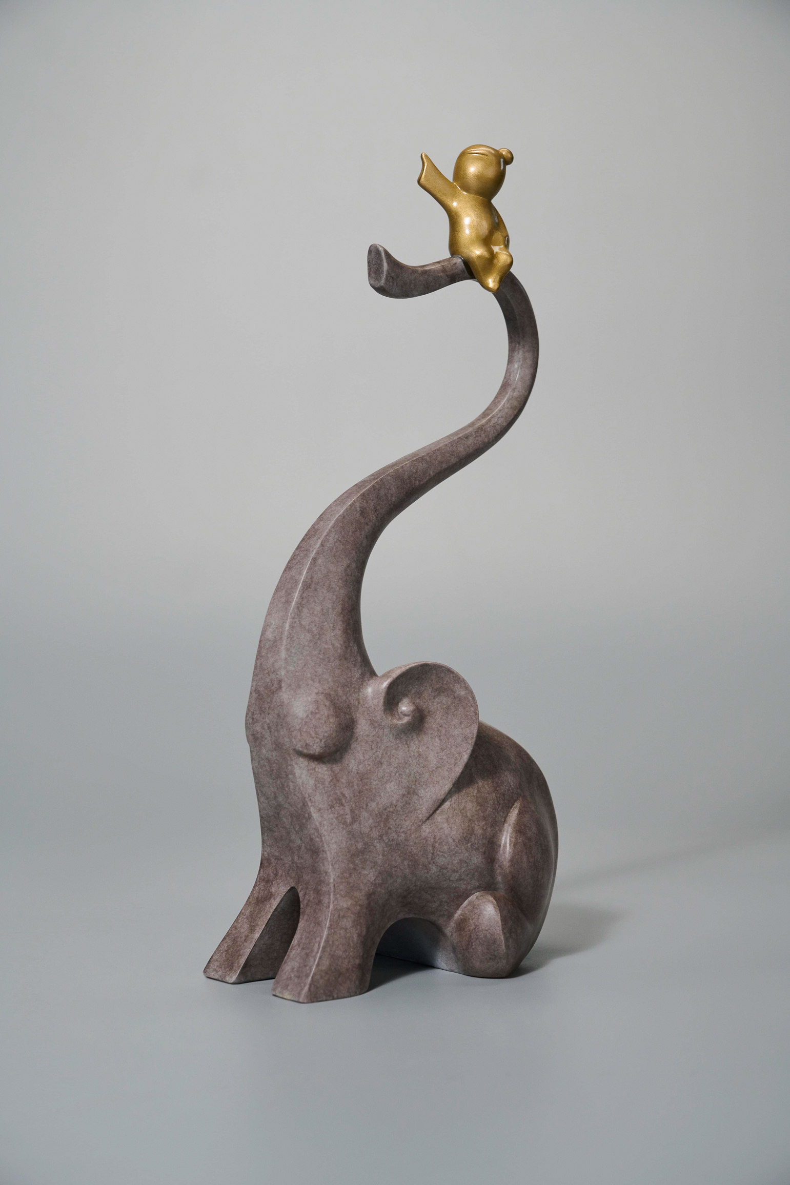 Two elephants with golden figures on trunks — single side view.