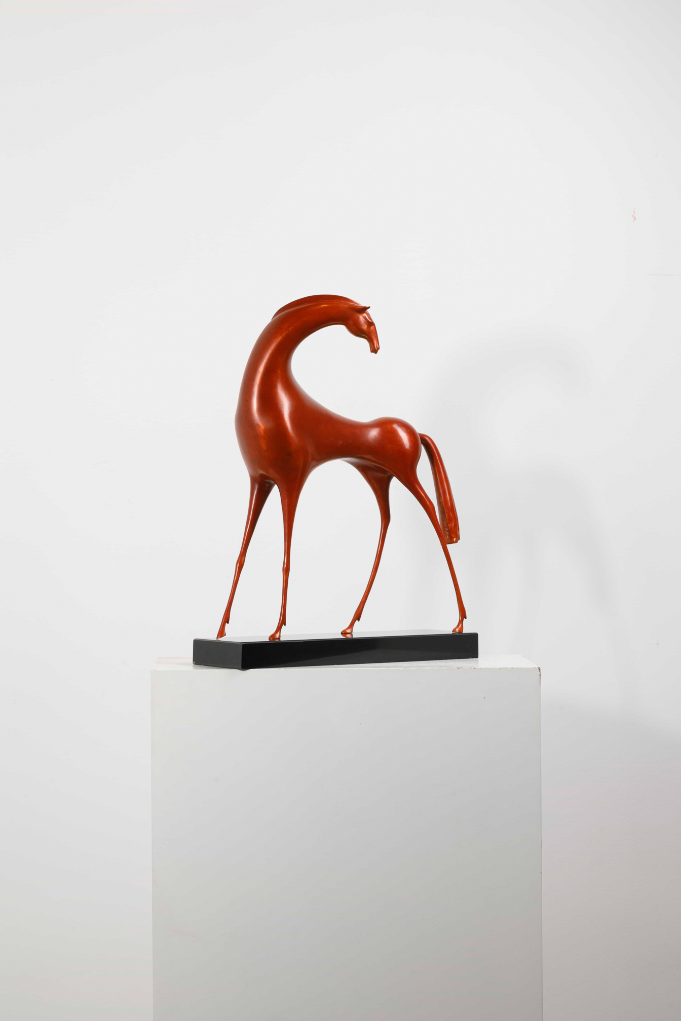 Abstract red horse with elongated legs — plinth view.