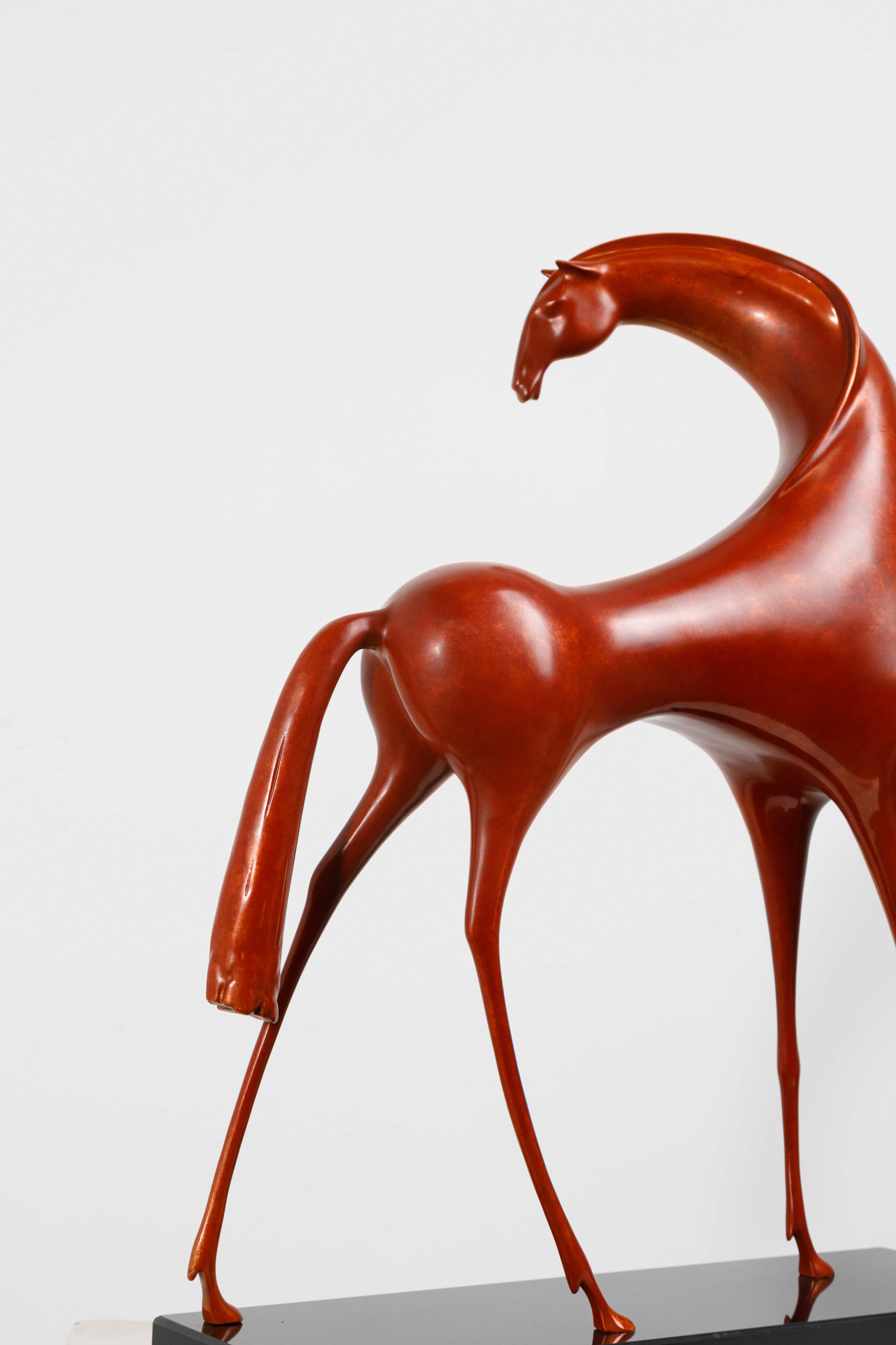 Abstract red horse with elongated legs — hindquarters close-up.