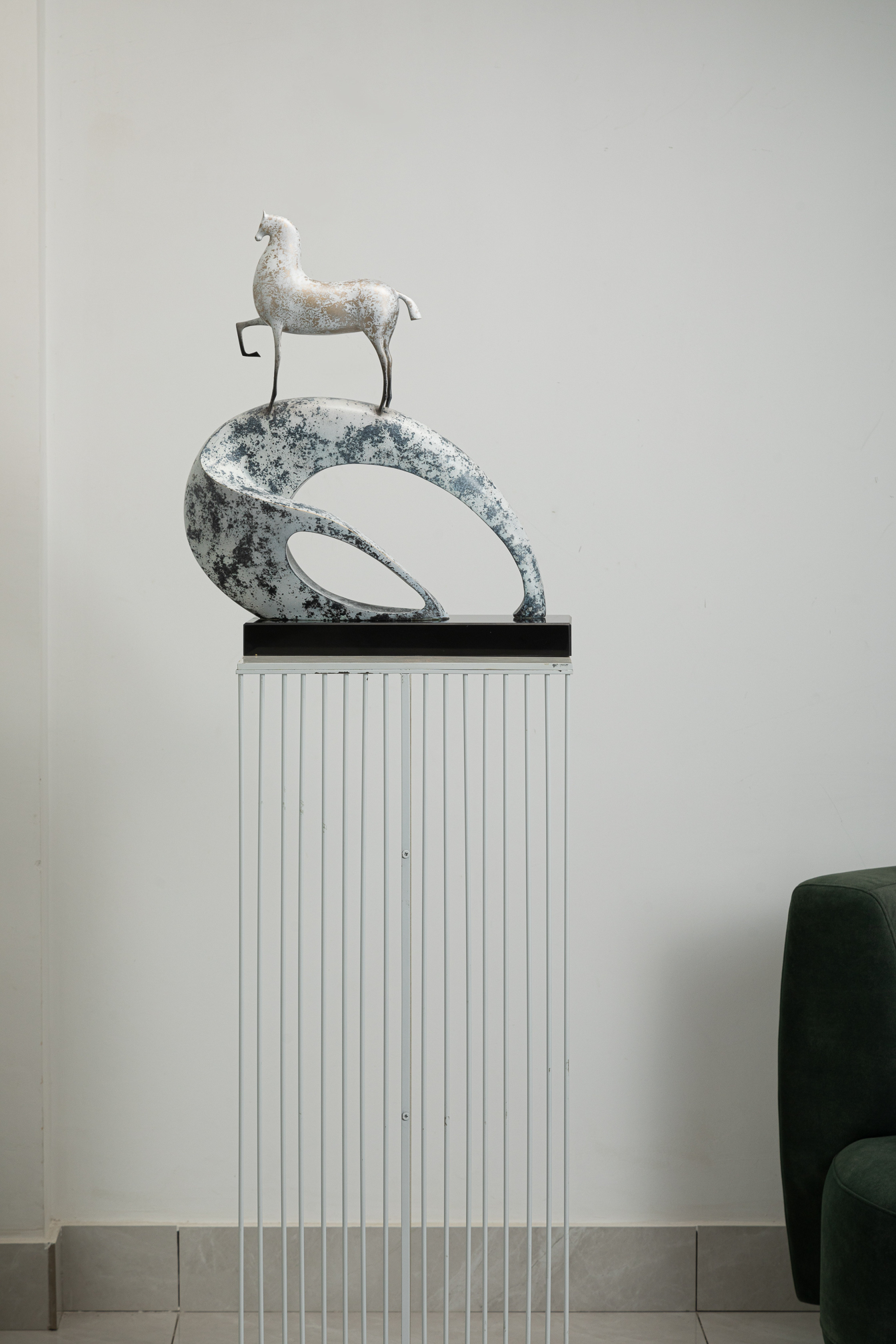 White horse climbing blue-and-white mottled arc base — interior styled view.
