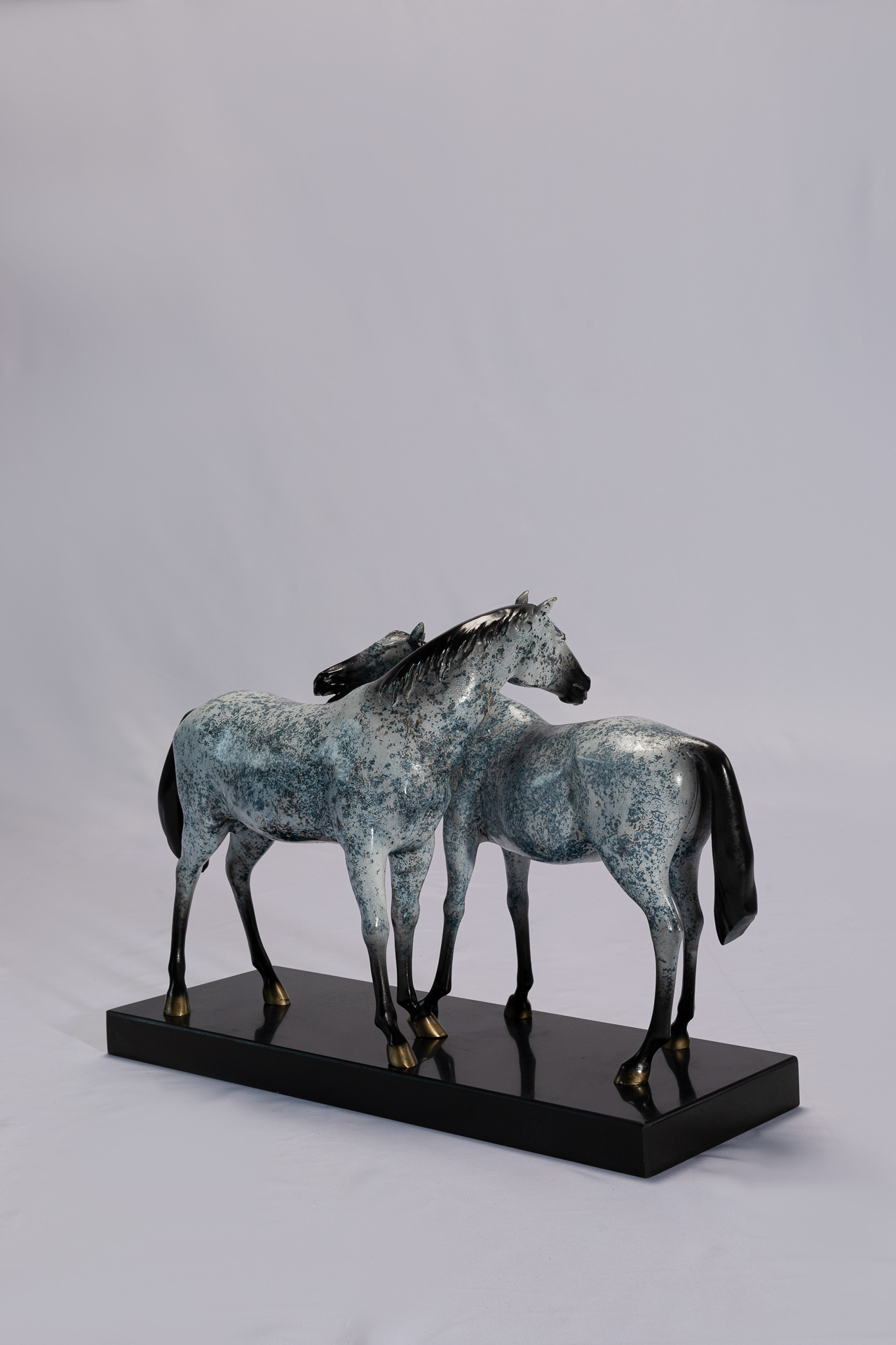 Grey patina pair of horses — pair three-quarter.